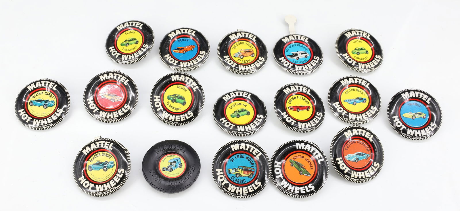 (18) HOT WHEELS RED LINE BUTTONS / BADGES: ONE IS MOLDED PLASTIC, THE REST ARE TIN LITHO. ONE MISSING HANG TAG. PLEASE READ CAREFULLY - TEMS MUST BE PAID FOR THROUGH LIVE AUCTIONEERS OR WITH CASH OR CHECK IN PERSON - Terms for Purchasing