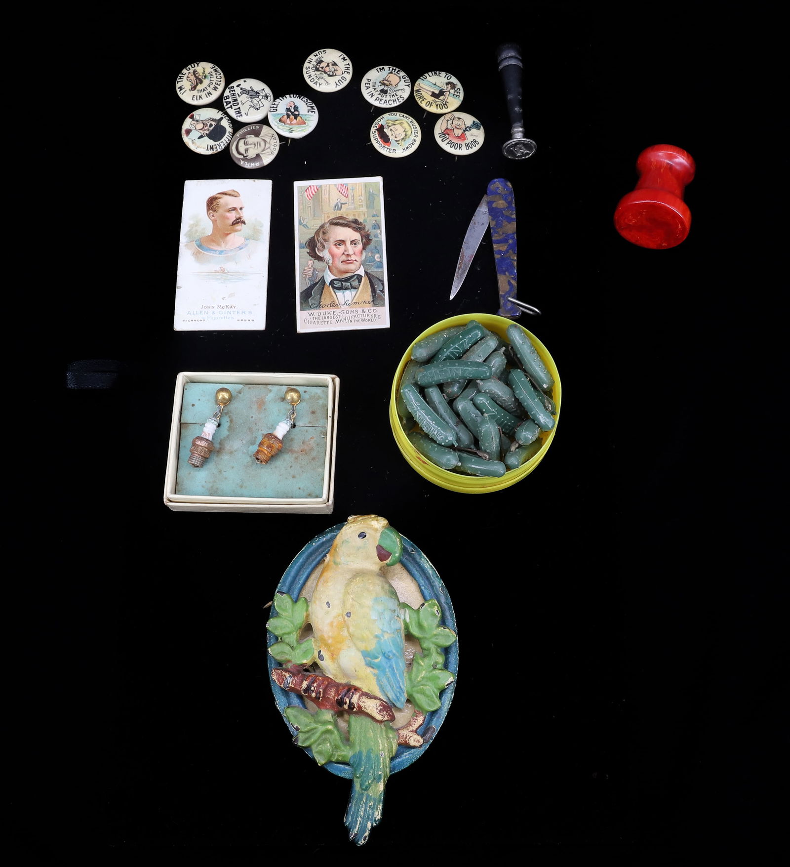 LOT OF TOBACCO PINS / CARDS, PINS, DOOR KNOCKER: CIGARETTE PINBACKS, TWO TOBACCO CARDS, "BABE RUTH" POCKET KNIFE, WAX MONOGRAMMER, SPARK PLUG EARRINGS, PLASTIC "HEINZ" PICKLE PINS, CAST IRON DOOR KNOCKER 4 1/2" L. BAKELITE RED PEDESTAL. PLEASE