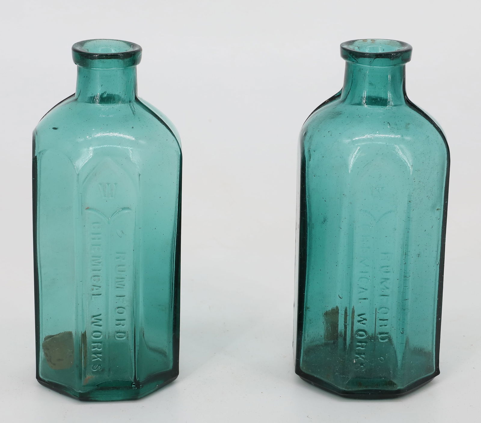 (2) RUMFORD CHEMICAL WORKS BOTTLES: OCTAGONAL W/ EMBOSSED NAME. 5 3/4" H. PLEASE READ CAREFULLY - TEMS MUST BE PAID FOR THROUGH LIVE AUCTIONEERS OR WITH CASH OR CHECK IN PERSON - Terms for Purchasing and Shipping of Auction Items. Pleas