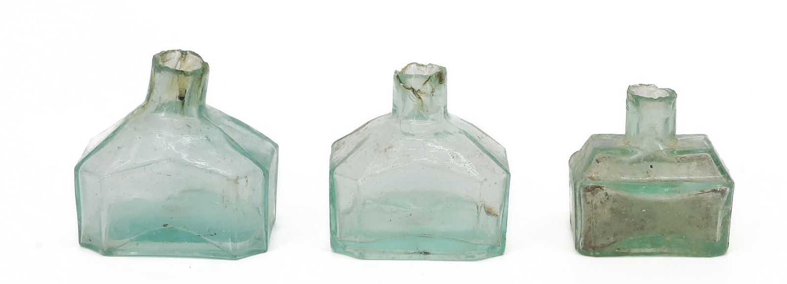 (3) 19TH C. GLASS INKWELLS: AQUA COLOR. (2) OCTAGONAL SHAPE WITH SHEARED LIPS. 2 1/4" AND 2 5/8" LENGTHS. SMALLEST HAS PEN REST ON EITHER SIDE. 2" L. PLEASE READ CAREFULLY - TEMS MUST BE PAID FOR THROUGH LIVE AUCTIONEERS