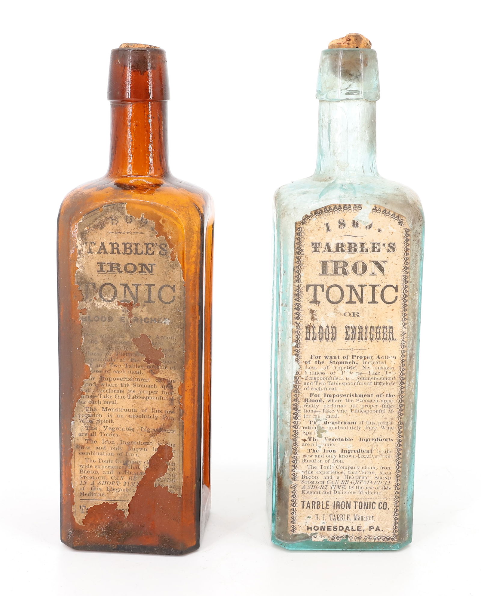 (2) HONESDALE, PA BOTTLES: AMBER AND LIGHT AQUA. "TARBLE'S IRON TONIC, HONESDALE, PA." PARTIAL ORIGINAL PAPER LABELS. 9 1/4" H. PLEASE READ CAREFULLY - TEMS MUST BE PAID FOR THROUGH LIVE AUCTIONEERS OR WITH CASH OR
