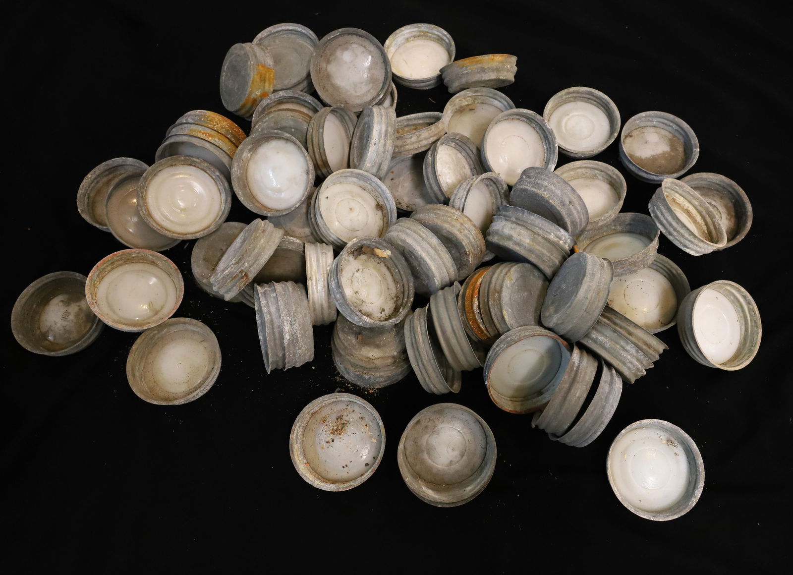 LOT OF ZINC FRUIT JAR LIDS: LARGE LOT OF ZINC LIDS (SOME WITH PORCELAIN INSERTS) 3" D. AT BOTTOM. PLEASE READ CAREFULLY - TEMS MUST BE PAID FOR THROUGH LIVE AUCTIONEERS OR WITH CASH OR CHECK IN PERSON - Terms for Purchasing