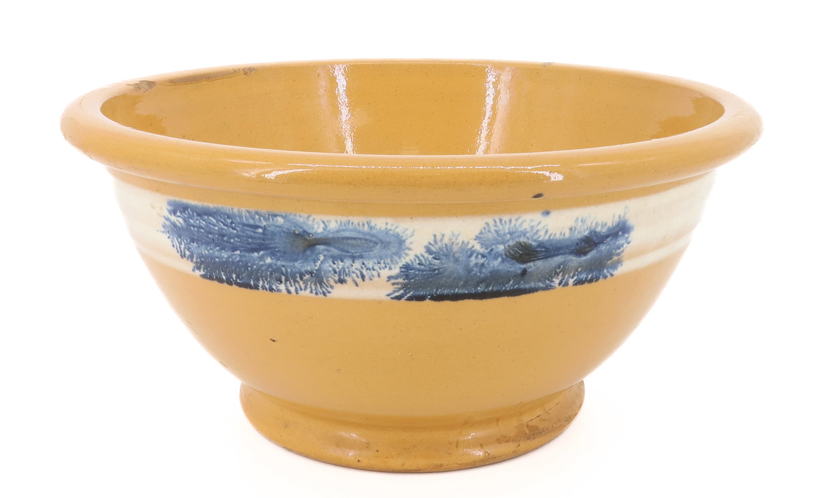 YELLOW WARE MIXING BOWL, SEAWEED DECORATION: YELLOW WARE WITH WHITE SLIP BAND AND BLUE SEAWEED DECORATION. 6 1/4" X 13 1/4". PLEASE READ CAREFULLY - ITEMS MUST BE PAID FOR THROUGH LIVE AUCTIONEERS OR WITH CASH OR CHECK IN PERSON - Terms