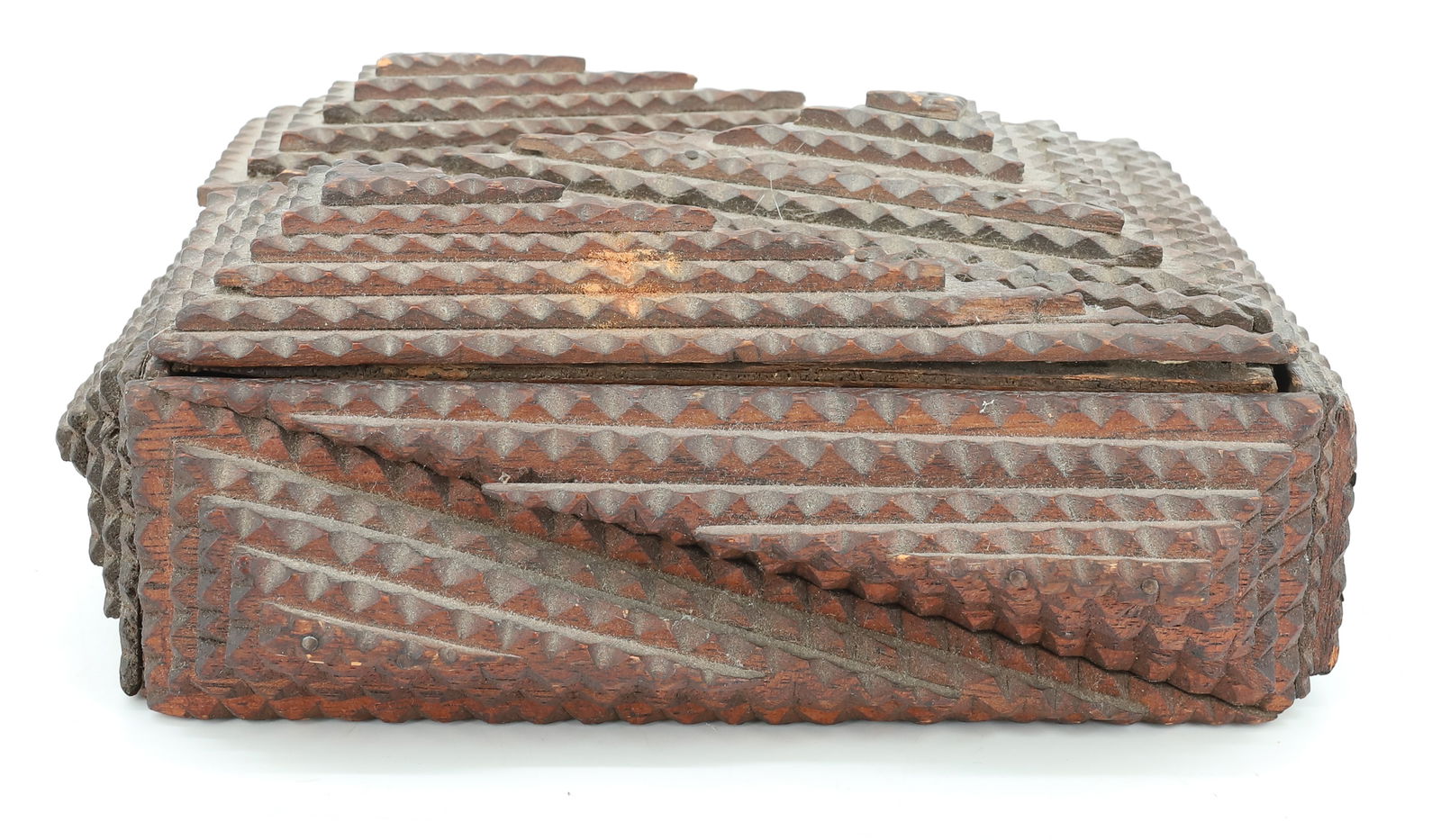 TRAMP ART CARVED BOX: LIFT-LID WITH CHIP CARVED LAYERS. INITIALS ON END "MFT". 8 3/4" L. CONSTRUCTED FROM WOODEN CIGAR BOXES. PLEASE READ CAREFULLY - ITEMS MUST BE PAID FOR THROUGH LIVE AUCTIONEERS OR WITH CASH OR