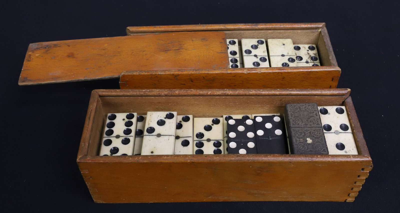 (2) SETS OF BONE / EBONY DOMINOES: (27) DOMINOES IN BOX W/ SLIDE LID. 1 7/8" L. BOX WITHOUT LID HAS (26) MATCHING 1 7/8". (WITH 5 THAT DO NOT EXACTLY MATCH). PLEASE READ CAREFULLY - ITEMS MUST BE PAID FOR THROUGH LIVE