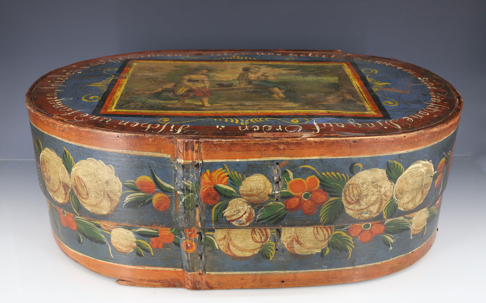 PAINTED GERMAN BRIDE'S BOX: FLORAL DECORATED BRIDE'S BOX WITH LITHOGRAPH OF CHILDREN ON TOP OF LID. GERMAN VERSE AROUND PERIMETER OF TOP LID. 7" X 19" X 12 1/4". PLEASE READ CAREFULLY - ITEMS MUST BE PAID FOR THROUGH LIVE