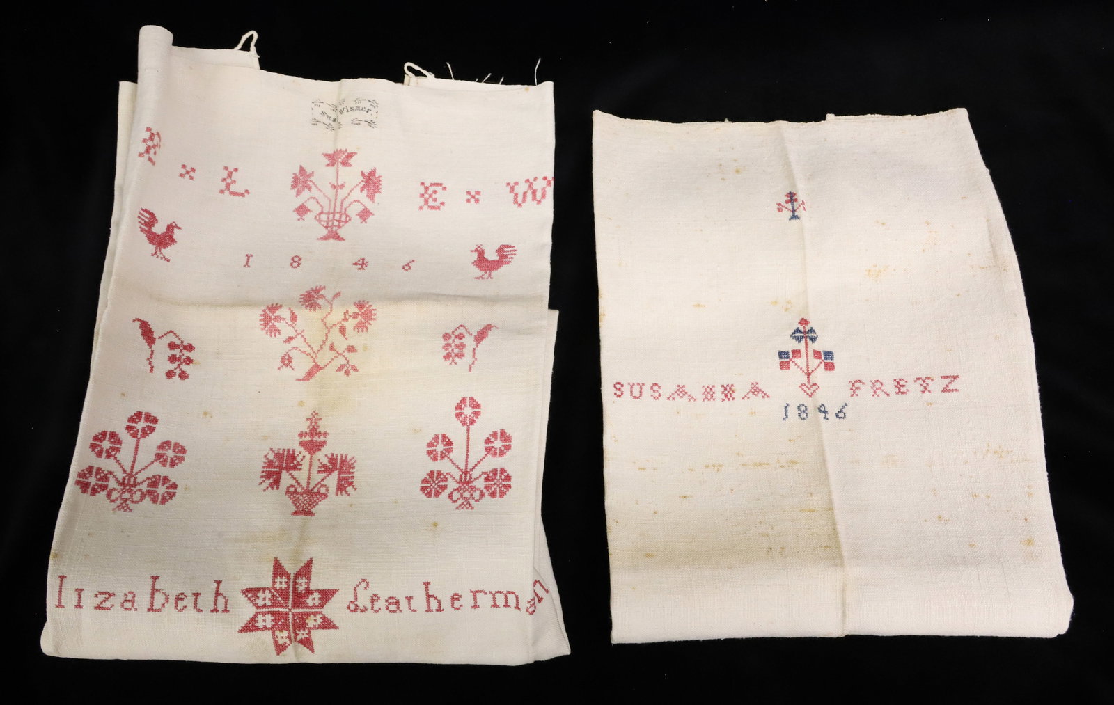 (2) 19TH C. SHOW TOWELS: ONE MRKD. "SUSANNA FRETZ, 1846" WITH BLUE / RED STITCHING. THE OTHER, "ELIZABETH LEATHERMAN, 1846". WITH RED STITCHING OF FLOWERS, ROOSTERS, POTTED PLANTS. STAMP AT TOP ".....WISMER". PLEASE