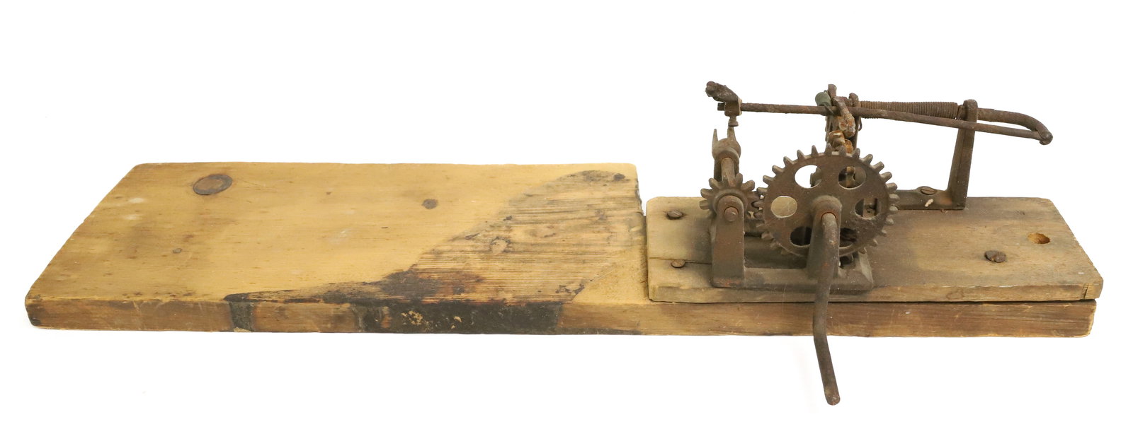 UNUSUAL 19TH C. CAST IRON APPLE PEELER: CRANK APPLE PEELER MOUNTED TO WOODEN BASE AND MOUNTED TO LARGER BOARD. PEELER IS 8" L. TOTAL LENGTH 24". PLEASE READ CAREFULLY - ITEMS MUST BE PAID FOR THROUGH LIVE AUCTIONEERS OR WITH CASH OR