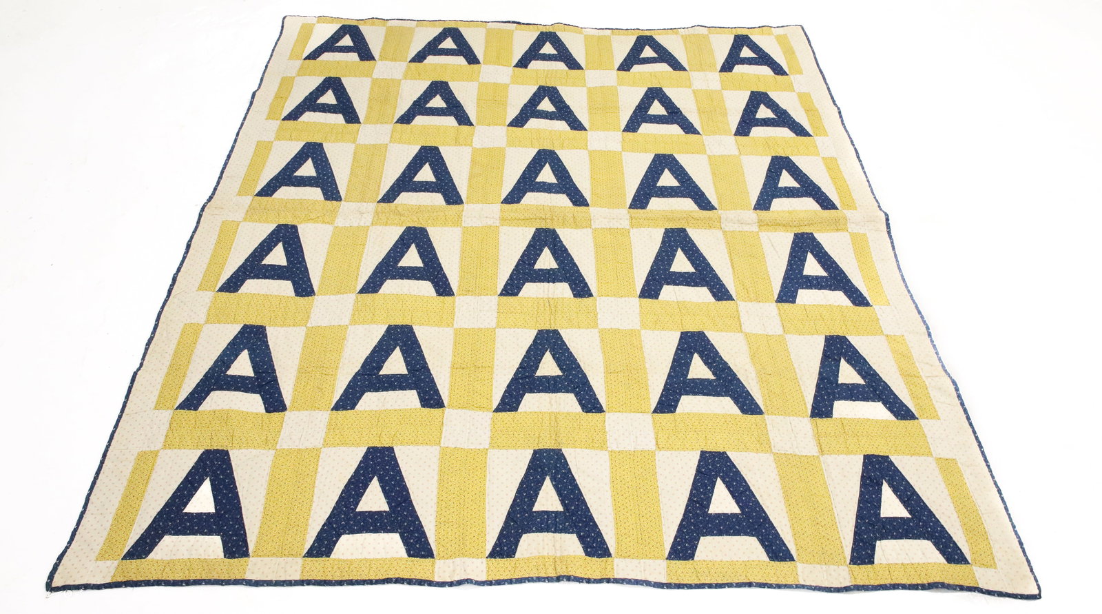 ANTIQUE HAND STITCHED "A" QUILT: VARIOUS PRINTED MATERIAL WITH SOLID FLORAL BACKING. 70" X 79". PLEASE READ CAREFULLY - ITEMS MUST BE PAID FOR THROUGH LIVE AUCTIONEERS OR WITH CASH OR CHECK IN PERSON - Terms for Purchasing and