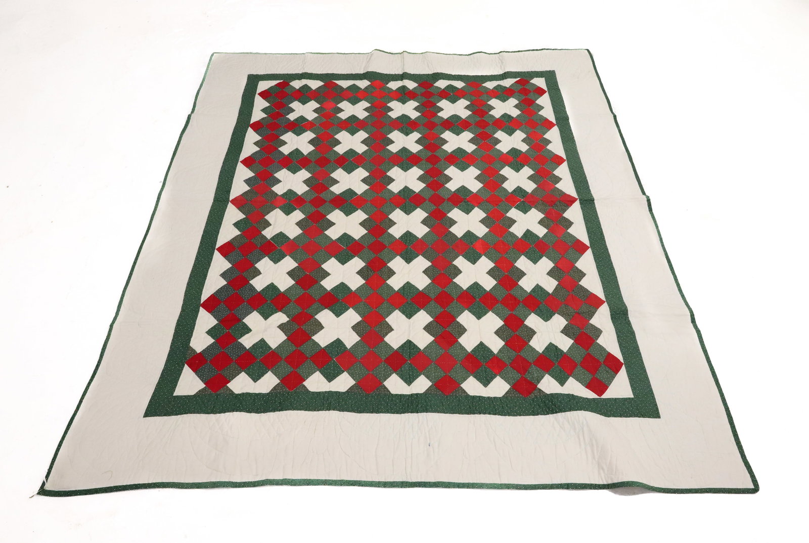 HAND STITCHED "CHRISTMAS" QUILT: RED / WHITE / GREEN PATTERN WITH STITCHING THROUGHOUT. SOLID WHITE BACKING. 80" X 69". PLEASE READ CAREFULLY - ITEMS MUST BE PAID FOR THROUGH LIVE AUCTIONEERS OR WITH CASH OR CHECK IN PERSON -