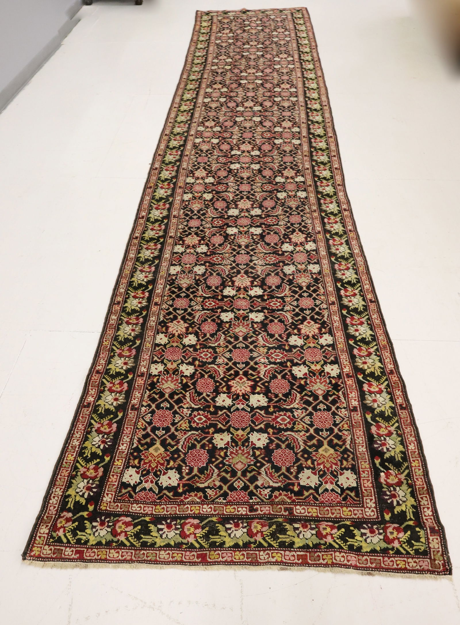 VINTAGE ORIENTAL RUNNER: BLACK / RED / PINK / OFF-WHITE. FLORAL WITH MULTIPLE BORDERS. 18 FEET X 44". PLEASE READ CAREFULLY - ITEMS MUST BE PAID FOR THROUGH LIVE AUCTIONEERS OR WITH CASH OR CHECK IN PERSON - Terms for