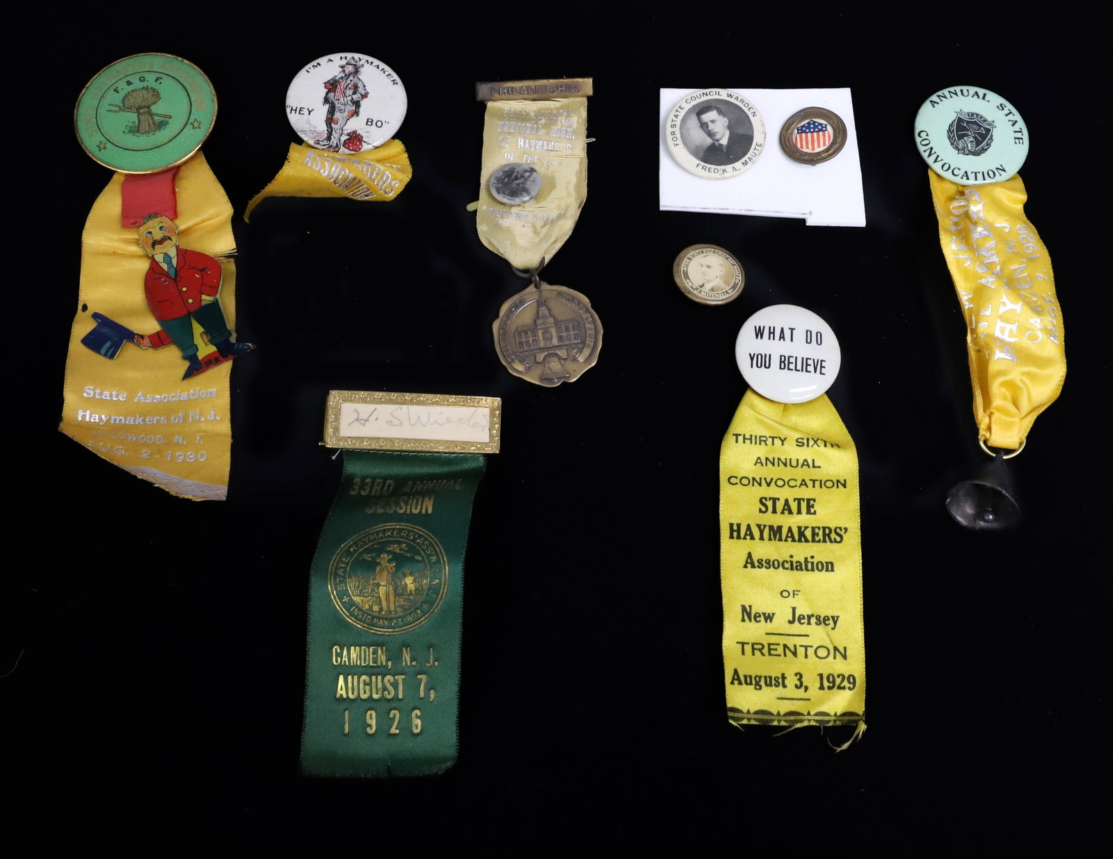 LOT OF NJ HAYMAKER'S PINS / RIBBONS: NEW JERSEY (TRENTON, PERTH AMBOY, CAMDEN, HOBOKEN, WILDWOOD) DATE RANGE FROM 1926-1930. PLUS, POLITICAL / PATRIOTIC PINS. PLEASE READ CAREFULLY - ITEMS MUST BE PAID FOR THROUGH LIVE AUCTIONEERS OR WIT