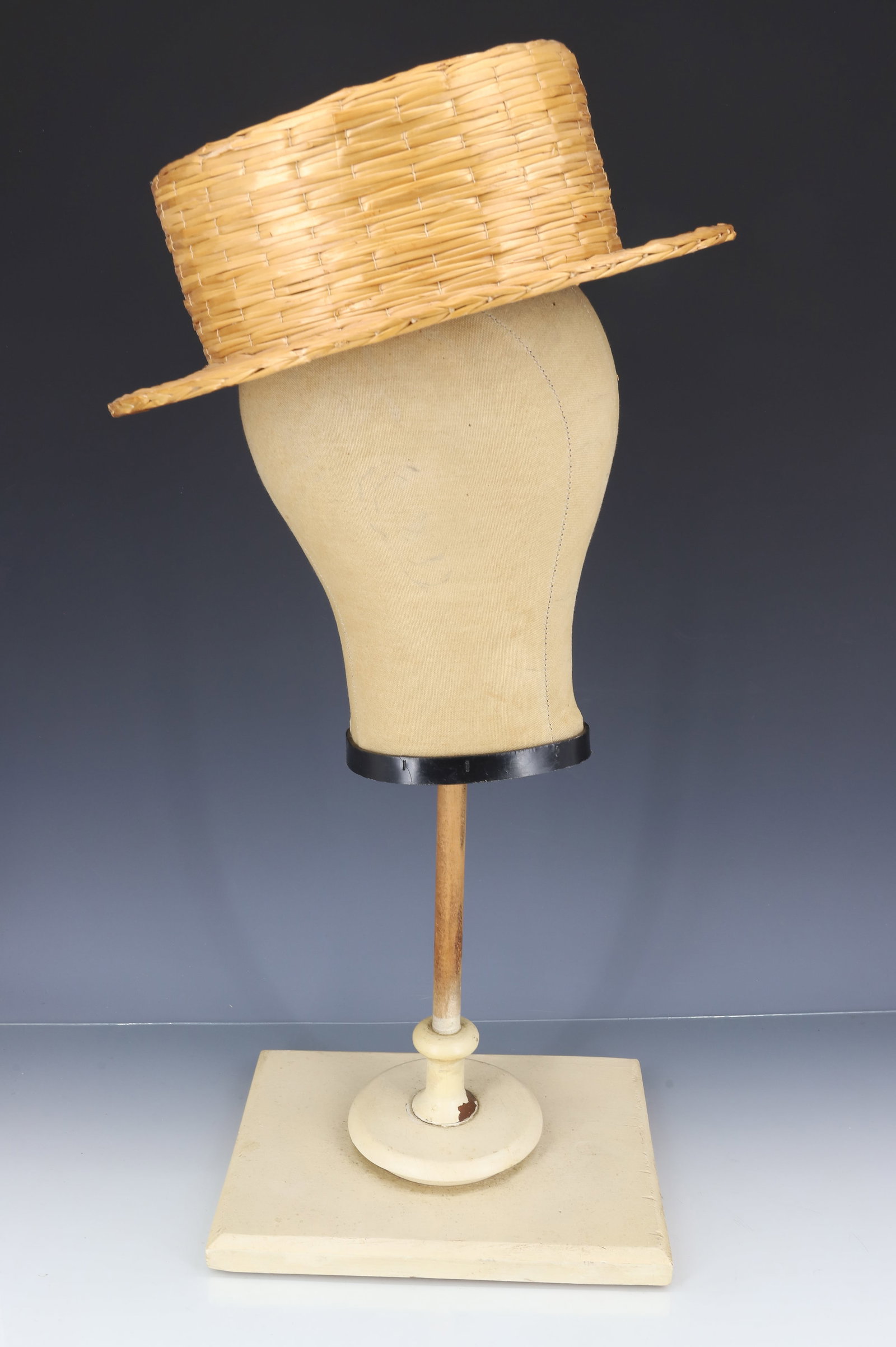 HAT DISPLAY STAND AND VINTAGE HAT: HEAD FORM ON WOODEN BASE. 20 1/4" H. WOVEN HAT (ITALY) EXPO '67 LABEL. PLEASE READ CAREFULLY - ITEMS MUST BE PAID FOR THROUGH LIVE AUCTIONEERS OR WITH CASH OR CHECK IN PERSON - Terms for Purchasing an