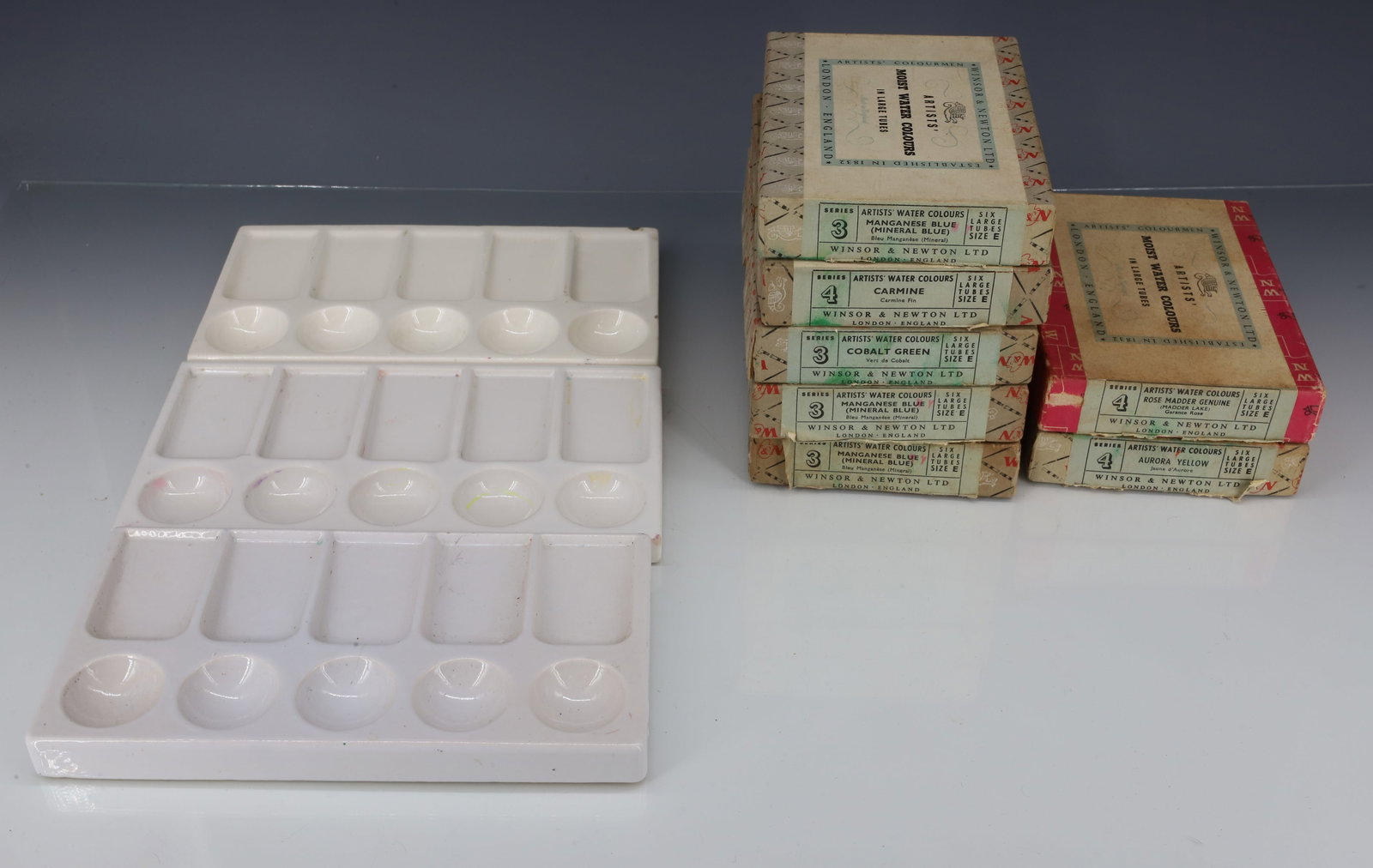 LOT OF VINTAGE WATER COLORS AND TRAYS: (7) BOXES OF WATER COLOR TUBES (WINSOR & NEWTON, ENGLAND) SIZE "E" LARGE TUBES. WITH, THREE PORCELAIN TRAYS. 7 5/8" L. PLEASE READ CAREFULLY - ITEMS MUST BE PAID FOR THROUGH LIVE AUCTIONEERS OR WITH C