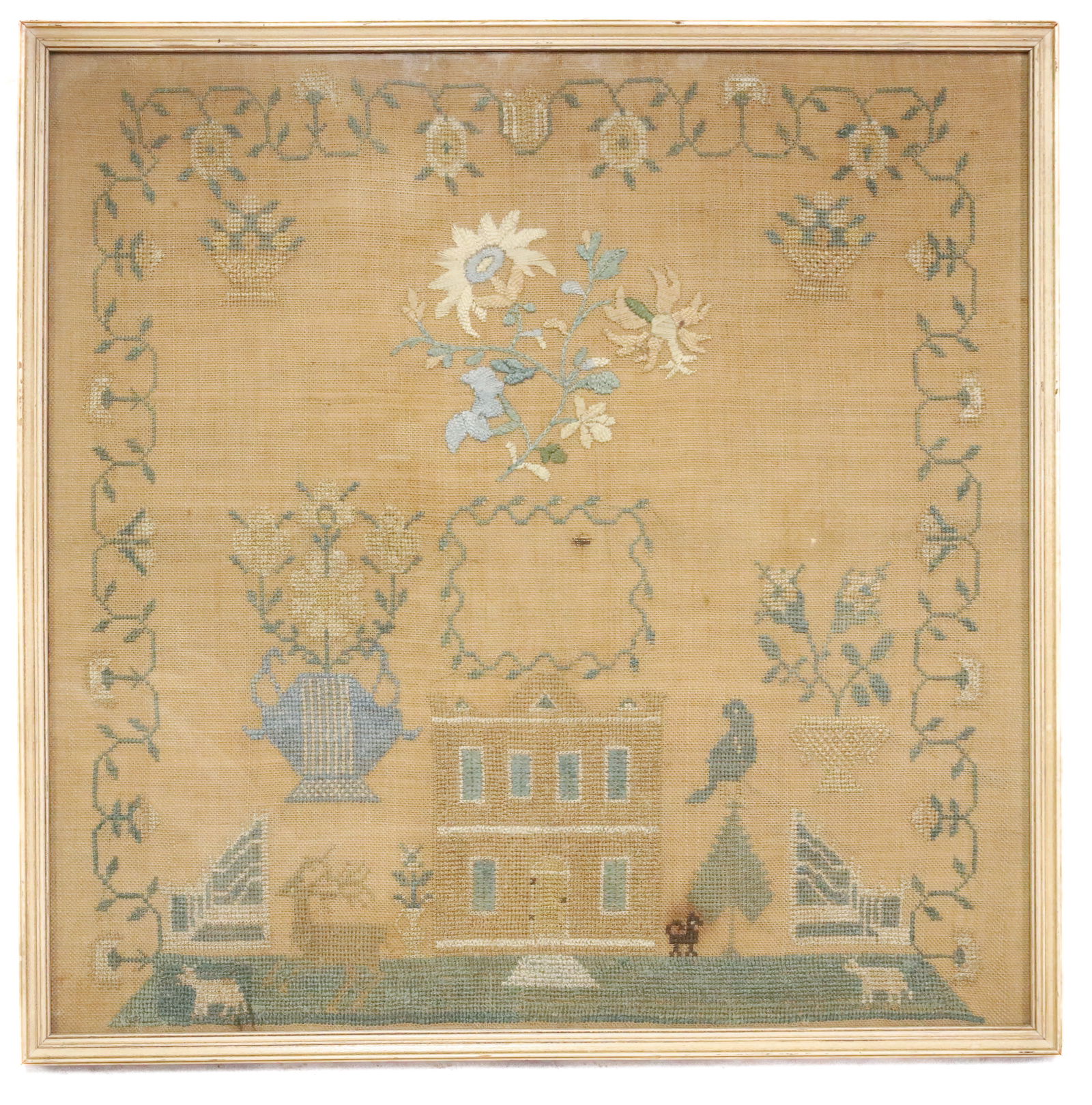 19TH C. FRAMED NEEDLEWORK SAMPLER: CENTRAL HOUSE SURROUNDED BY TREES AND ANIMALS. FLORAL URNS AND BASKETS ABOVE WITH FLOWERS IN CENTER AND AROUND BORDER. FRAMED UNDER GLASS. TOTAL SIZE 17 1/2" X 17 1/2". PLEASE READ CAREFULLY -