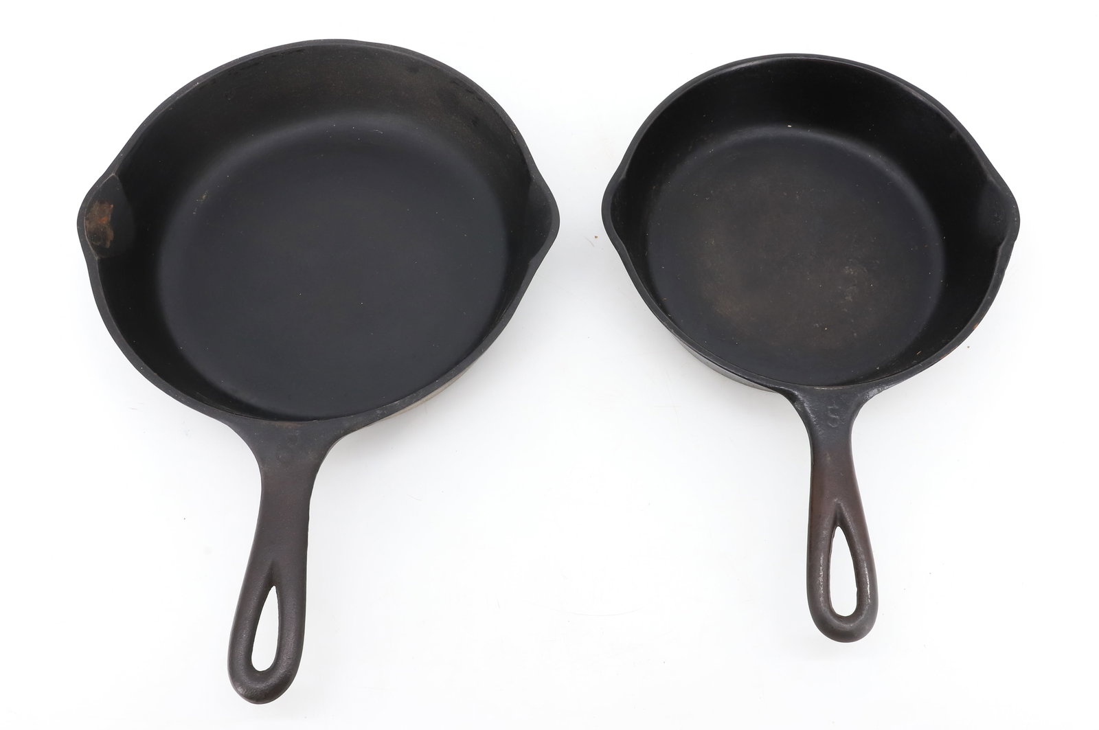 (2) CAST IRON SKILLETS: UNMARKED #5 (7 7/8" D.) AND WAGNER WARE #6 (9" D.) PLEASE READ CAREFULLY - ITEMS MUST BE PAID FOR THROUGH LIVE AUCTIONEERS OR WITH CASH OR CHECK IN PERSON - Terms for Purchasing and Shipping of Auctio