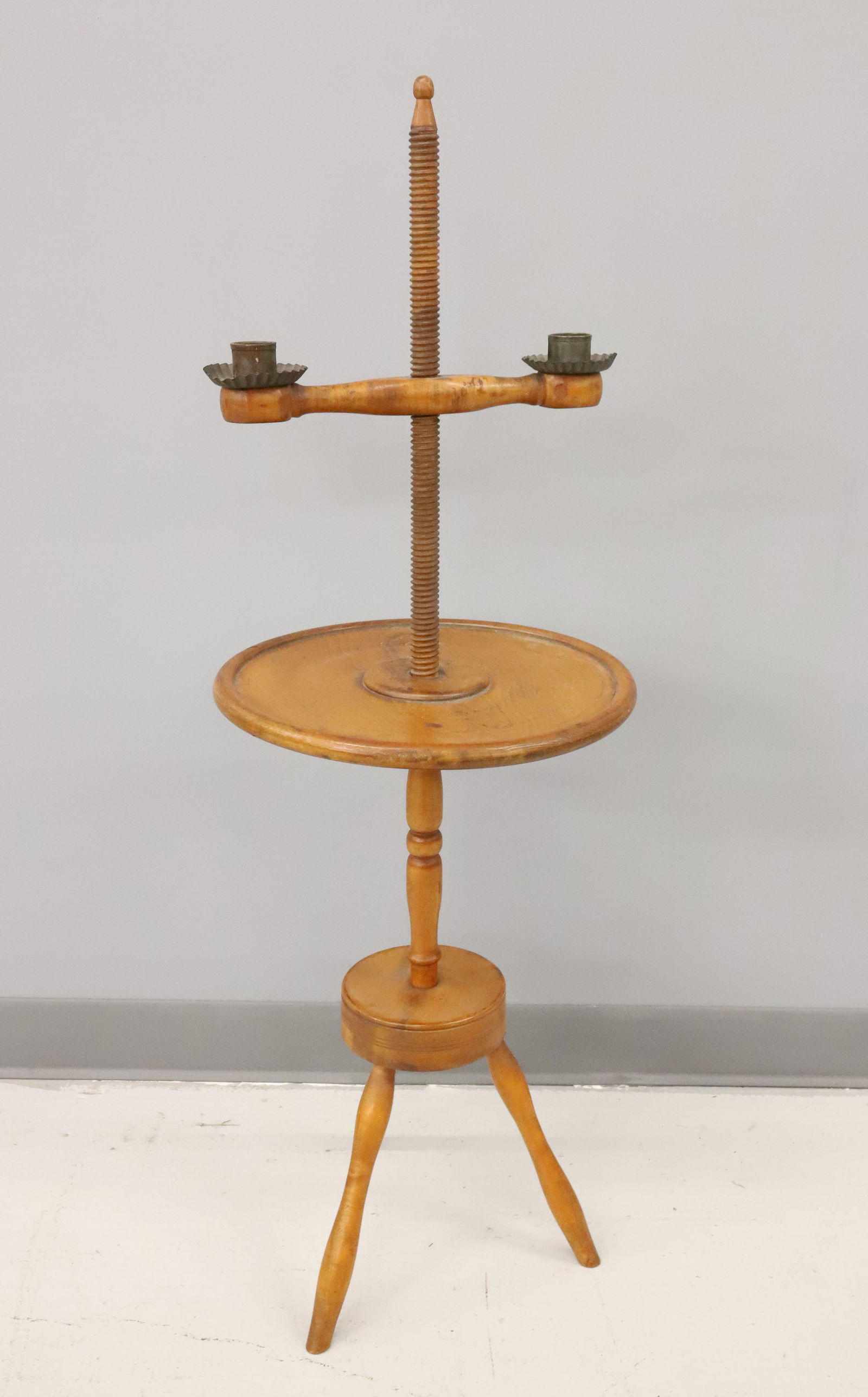 ADJUSTABLE COUNTRY CANDLEHOLDER: TWO REVOLVING CANDLE HOLDERS WITH TIN WAX TRAYS. REVOLVES UP AND DOWN TO ADJUST HEIGHT. 41" X 14". PLEASE READ CAREFULLY - ITEMS MUST BE PAID FOR THROUGH LIVE AUCTIONEERS OR WITH CASH OR CHECK IN PERS