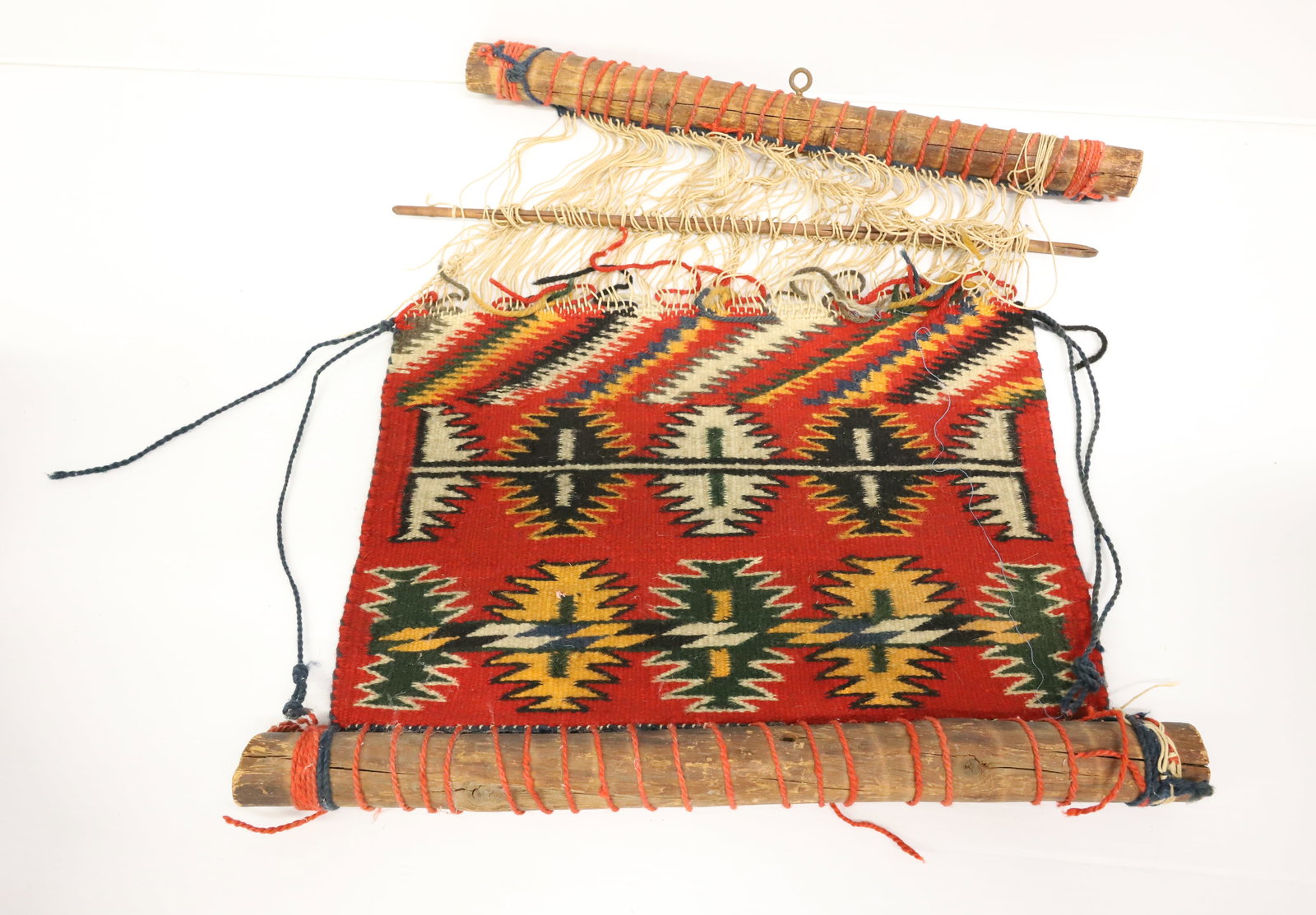 NAVAJO WEAVING SAMPLER: HANDWOVEN TEXTILE (GERMANTOWN-STYLE) ON WOODEN LOOM. 17" X 15 1/2". PLEASE READ CAREFULLY - ITEMS MUST BE PAID FOR THROUGH LIVE AUCTIONEERS OR WITH CASH OR CHECK IN PERSON - Terms for Purchasing