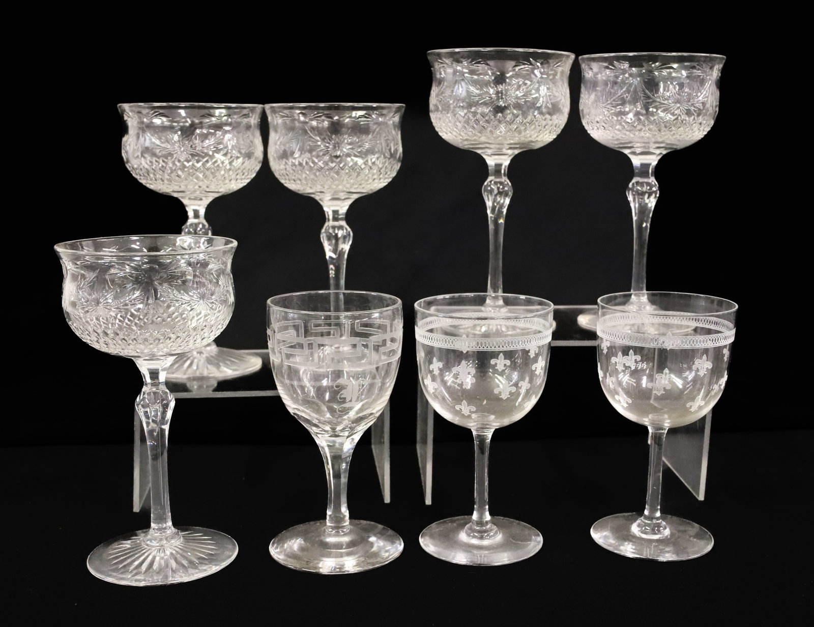 (8) DORFLINGER ENGRAVED WINE GLASSES: (5) MATCHING IN DAISY AND SWAG, ONE PAIR OF FLEUR DE LIS AND ONE GREEK KEY 4 3/4" TO 6"H PLEASE READ CAREFULLY - ITEMS MUST BE PAID FOR THROUGH LIVE AUCTIONEERS OR WITH CASH OR CHECK IN PERSON - Terms