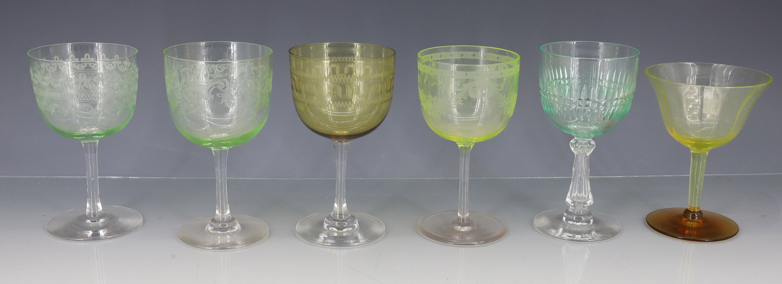 (6) DORFLINGER ENGRAVED WINE GLASSES: URANIUM, CELERY, AMBER AND LIGHT GREEN COLORS ONE CUT GLASS WITH CUT STEM, ONE URANIUM WITH AMBER FOOT 4" TO 4 5/8" PLEASE READ CAREFULLY - ITEMS MUST BE PAID FOR THROUGH LIVE AUCTIONEERS OR WITH CASH