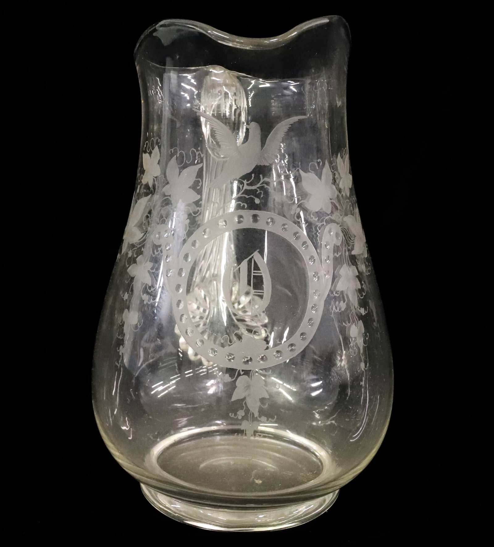 BLOWN AND ENGRAVED PITCHER: CLEAR GLASS WITH APPLIED REEDED HANDLE, ENGRAVED IVY VINE, DOVE ON BRANCH AND MONOGRAM POLISHED PONTIL 9 1/2"H PLEASE READ CAREFULLY - ITEMS MUST BE PAID FOR THROUGH LIVE AUCTIONEERS OR WITH CASH OR C