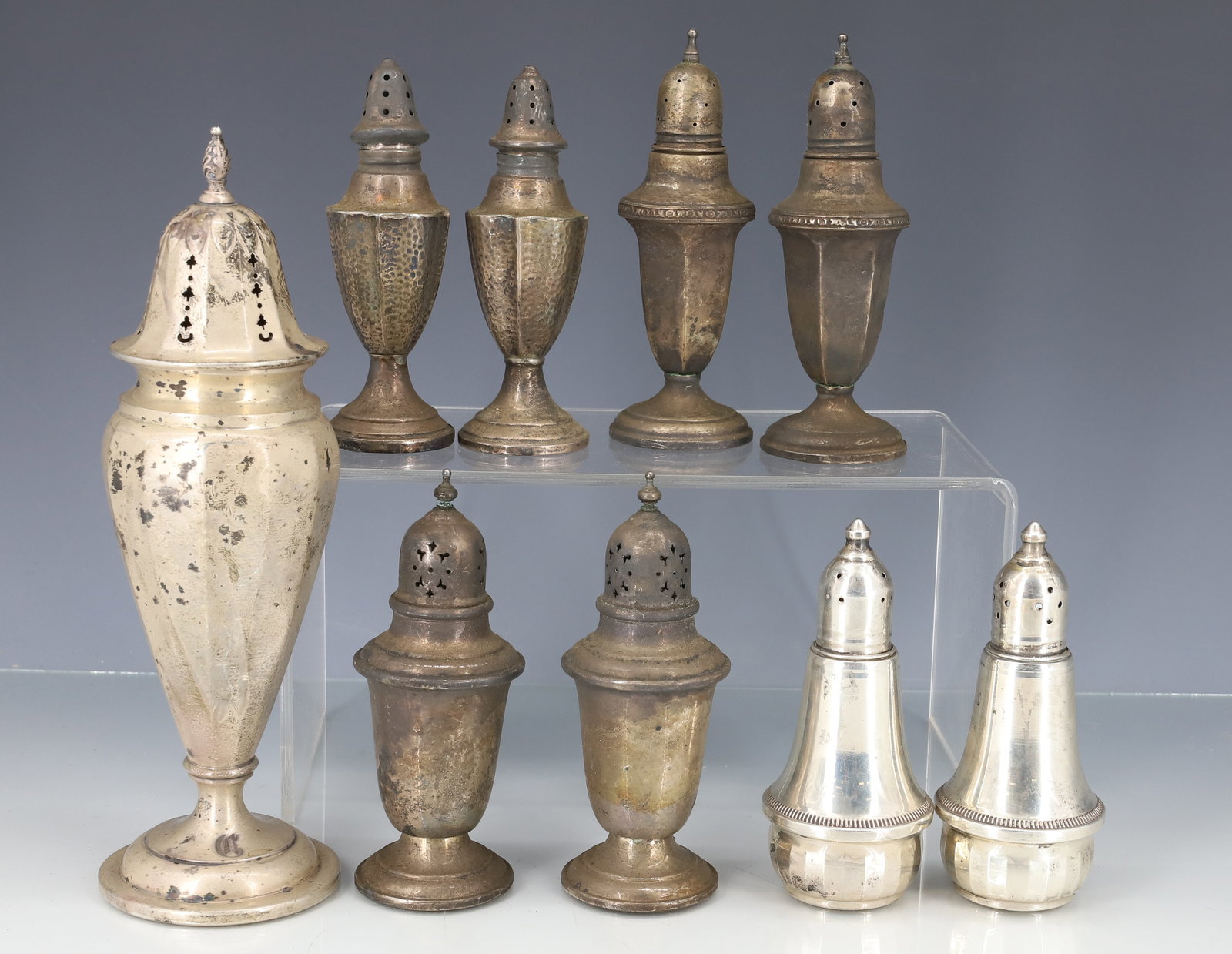 STERLING SILVER MUFFINEER AND SHAKERS: (11) WEIGHTED MUFFINEER ,(2) PAIR SHAKERS, ONE PAIR GLASS LINED, AND ONE PAIR HOLLOWARE 4" TO 7 3/4" PLEASE READ CAREFULLY - ITEMS MUST BE PAID FOR THROUGH LIVE AUCTIONEERS OR WITH CASH OR CHECK IN PE