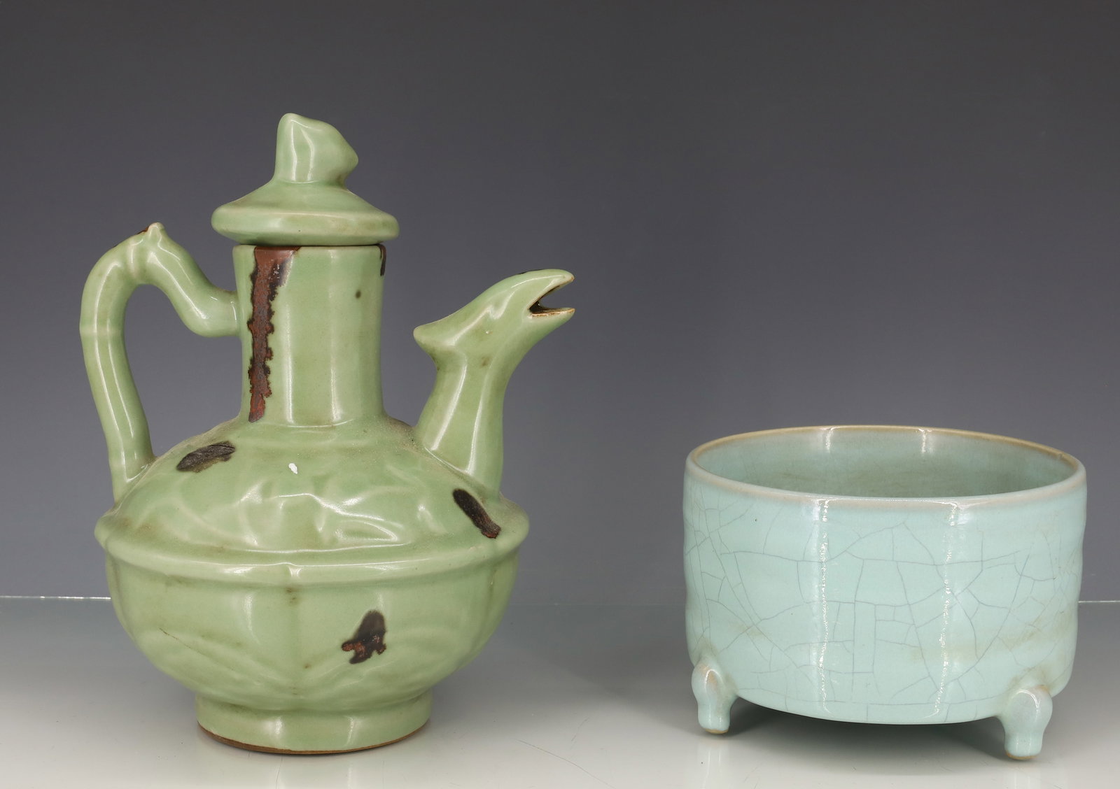 CHINESE CELADON GLAZE TEAPOT/BOWL: DRAGON SPOUT TEAPOT IN DARK GREEN CELADON AND THREE FOOTED BOWL WITH CRACKLE GLAZE 8 1/2"H, 3 1/2" X 5 1/4"DIA PLEASE READ CAREFULLY - ITEMS MUST BE PAID FOR THROUGH LIVE AUCTIONEERS OR WITH CASH OR C
