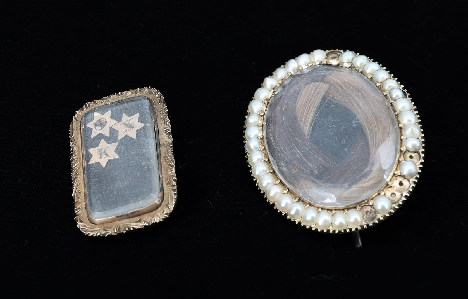 (2) 10K ANTIQUE HAIR MOURNING BROOCHES: OVAL WITH SEED PEARL AND WOVEN HAIR, RECTANGLE ON REVERSE J.T. WORTHINGTON (3) STARS AND CHURCH STEEPLE 1842 UNDER GLASS BEZEL THREE STARS WITH K.O.X. BACKGROUND IS CLOTH 1 1/2" X 1", 1" X 1/2" TOTAL