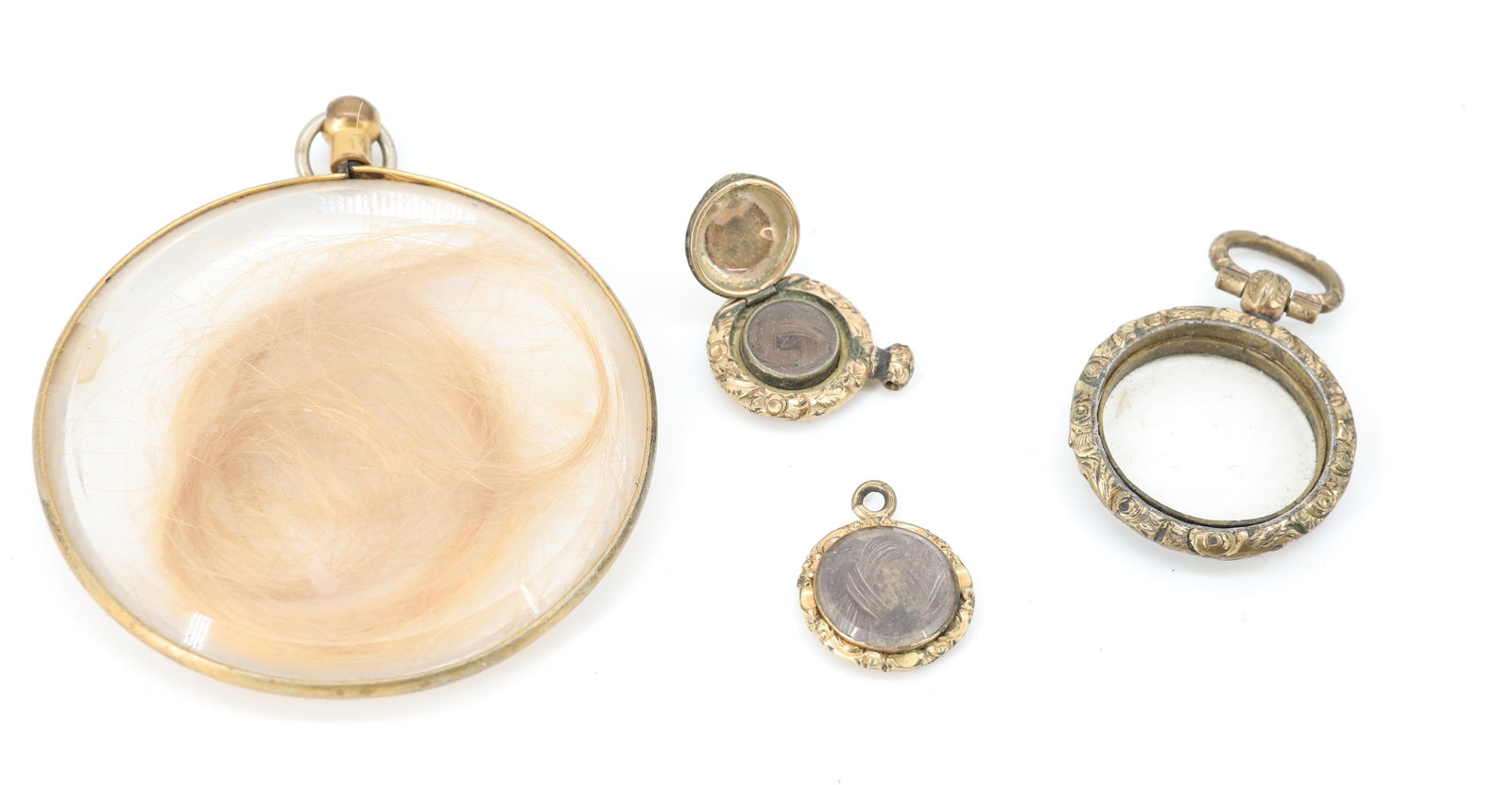 (4) 10K GOLD HAIR JEWELRY LOT: SMALL LOCKET WITH WOVEN HAIR 10K GOLD TESTED, CHARM WITH WOVEN HAIR TESTED 10K WITH LARGE PENDANT BEVELED CONVEX GLASS AND BLONDE HAIR , EMPTY LOCKET MISSING BACK GOLD WEIGHT 3. DWT PLEASE READ CAREFU