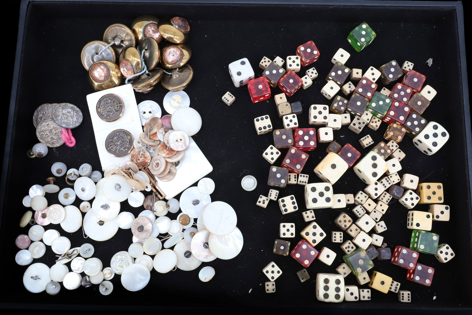 BUTTON AND DICE LOT: MOTHER OF PEARL BUTTONS, METAL BUTTON, BRASS BUTTONS WITH PINK JEWELS, DICE OF ALL SIZES LUCITE AND RESIN 1"DIA PLEASE READ CAREFULLY - ITEMS MUST BE PAID FOR THROUGH LIVE AUCTIONEERS OR WITH CASH OR