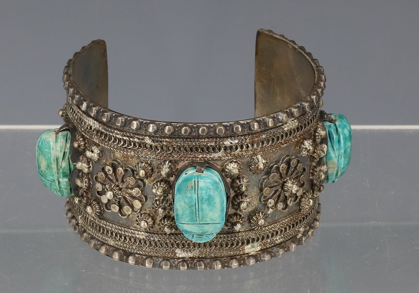 SILVER CUFF WITH SCARABS: EGYPTIAN HAND WROUGHT SILVER CUFF WITH THREE POTTERY BEAD SCARABS SILVER CONTENT 800/900 SILVER TOTAL WEIGHT 3.08 OZT PLEASE READ CAREFULLY - ITEMS MUST BE PAID FOR THROUGH LIVE AUCTIONEERS OR WITH CA