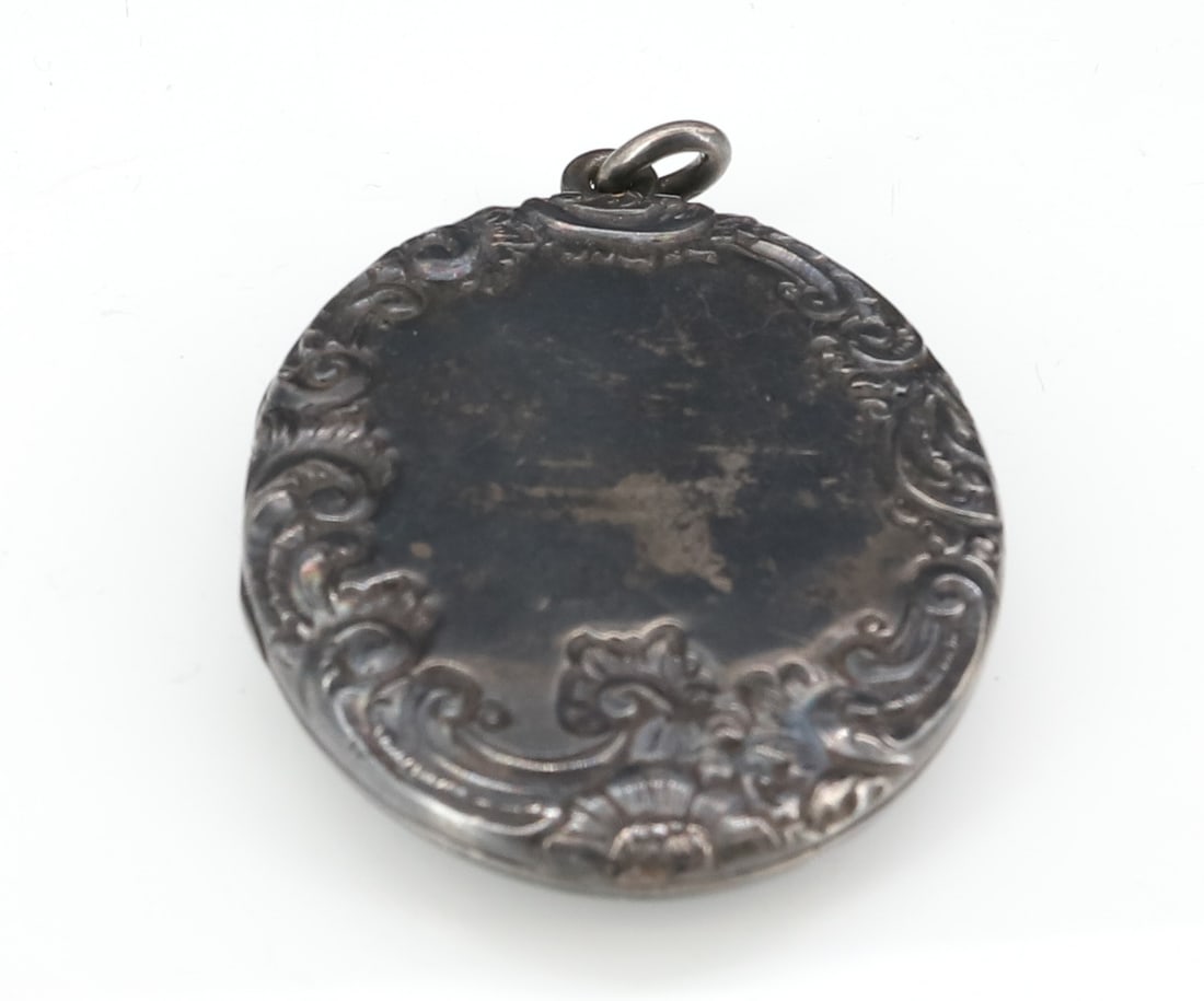 STERLING SILVER LOCKET WITH TINTYPE: 2 1/4" X 1 5/8" INTERIOR FEMALE TINTYPE AND MIRROR TESTED STERLING SILVER TOTAL WEIGHT .85 OZT PLEASE READ CAREFULLY - ITEMS MUST BE PAID FOR THROUGH LIVE AUCTIONEERS OR WITH CASH OR CHECK IN PERSON -