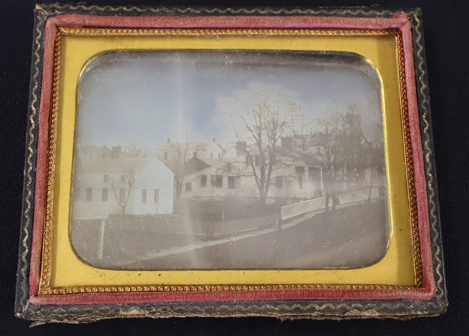 19TH C. DAGUERREOTYPE OF HOUSES, STREET SCENE: HOUSES WITH WOODEN FENCING AND TREES. 3 1/4" X 4 1/4". TOOLED LEATHER CASE. PLEASE READ CAREFULLY - ITEMS MUST BE PAID FOR THROUGH LIVE AUCTIONEERS OR WITH CASH OR CHECK IN PERSON - Terms for Purchasi