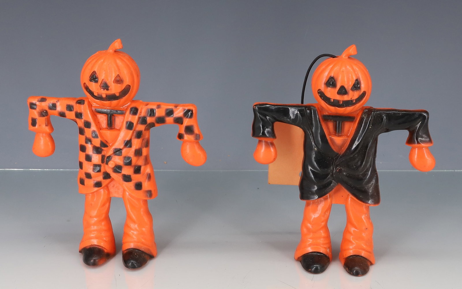 (2) HALLOWEEN SCARECROW CANDY CONTAINERS: MOLDED PLASTIC. ONE WITH HANG TAG. 5" H. PLEASE READ CAREFULLY - ITEMS MUST BE PAID FOR THROUGH LIVE AUCTIONEERS OR WITH CASH OR CHECK IN PERSON - Terms for Purchasing and Shipping of Auction