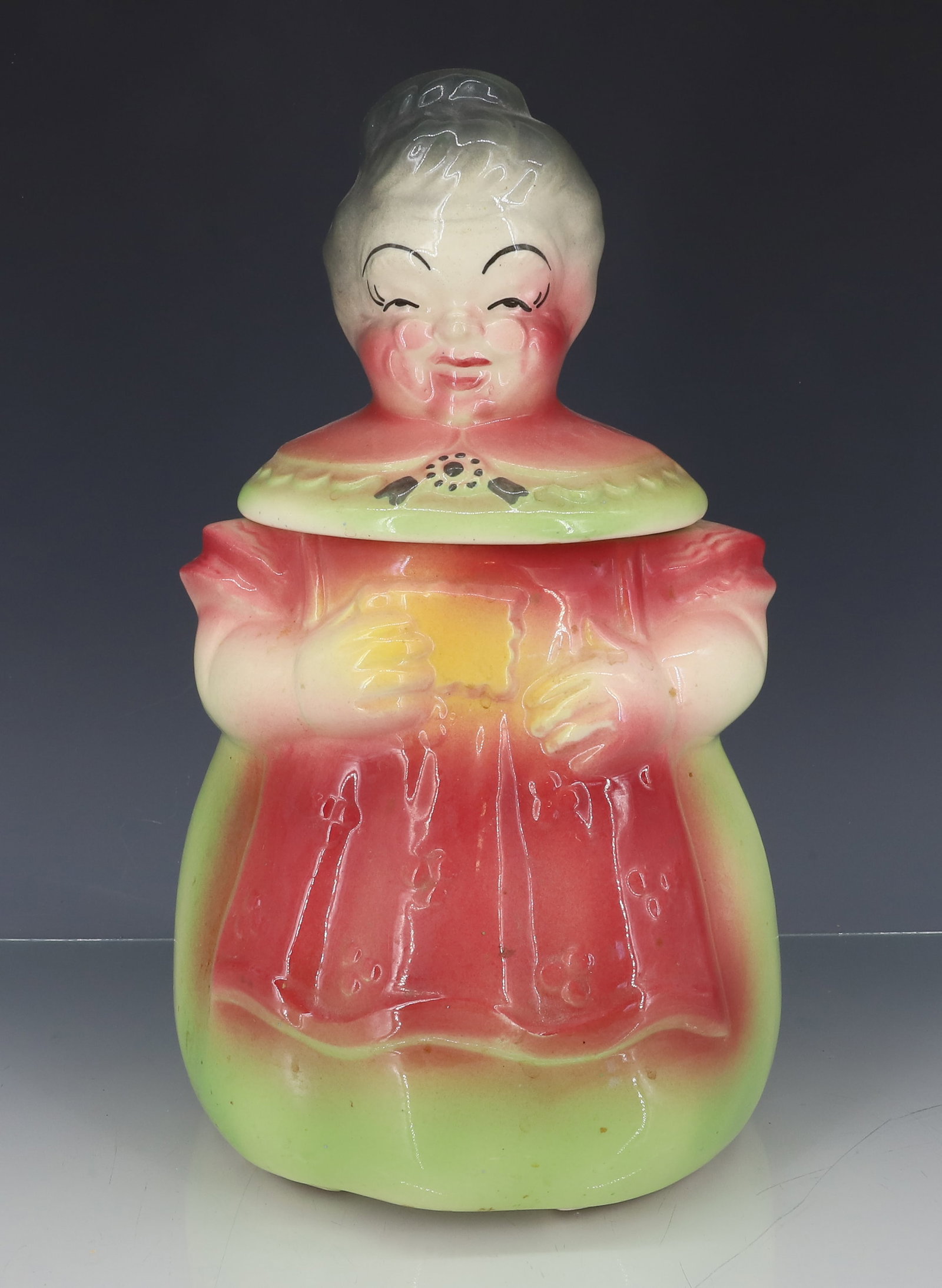 AMERICAN BISQUE "GRANNY" COOKIE JAR: COLORFUL SURFACE. UNMARKED. 12 1/4" H. PLEASE READ CAREFULLY - ITEMS MUST BE PAID FOR THROUGH LIVE AUCTIONEERS OR WITH CASH OR CHECK IN PERSON - Terms for Purchasing and Shipping of Auction Items. Ple