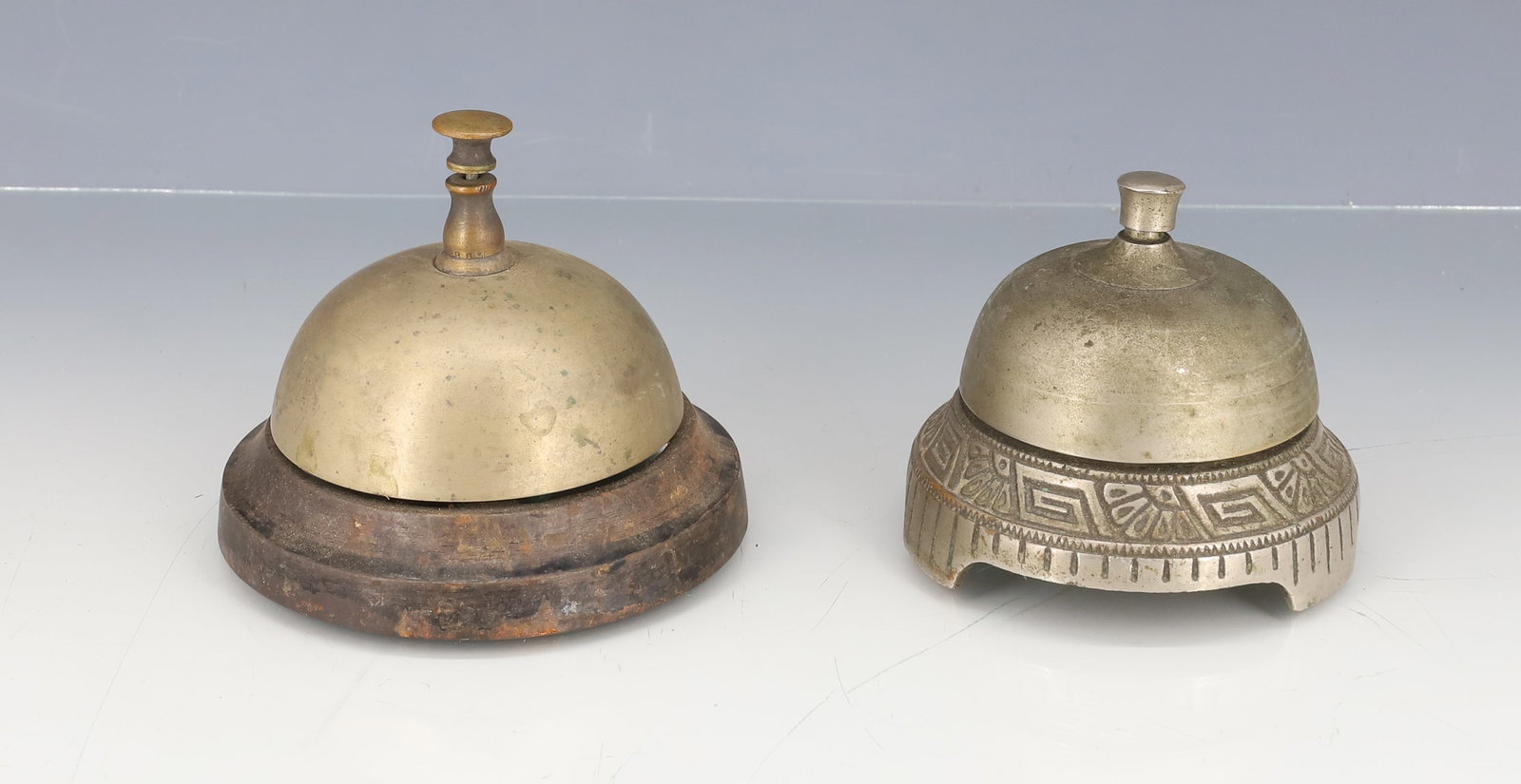 (2) ANTIQUE COUNTER BELLS: NICKEL-BRASS WITH CAST IRON BASE. LARGER IS PAT. 1863. SMALLER MRKD. "NEW DEPARTURE BELL COMPANY, BRISTOL, CONN" BELL WINDS FOR CONTINUOUS RING. PLEASE READ CAREFULLY - ITEMS MUST BE PAID FOR THROUGH 