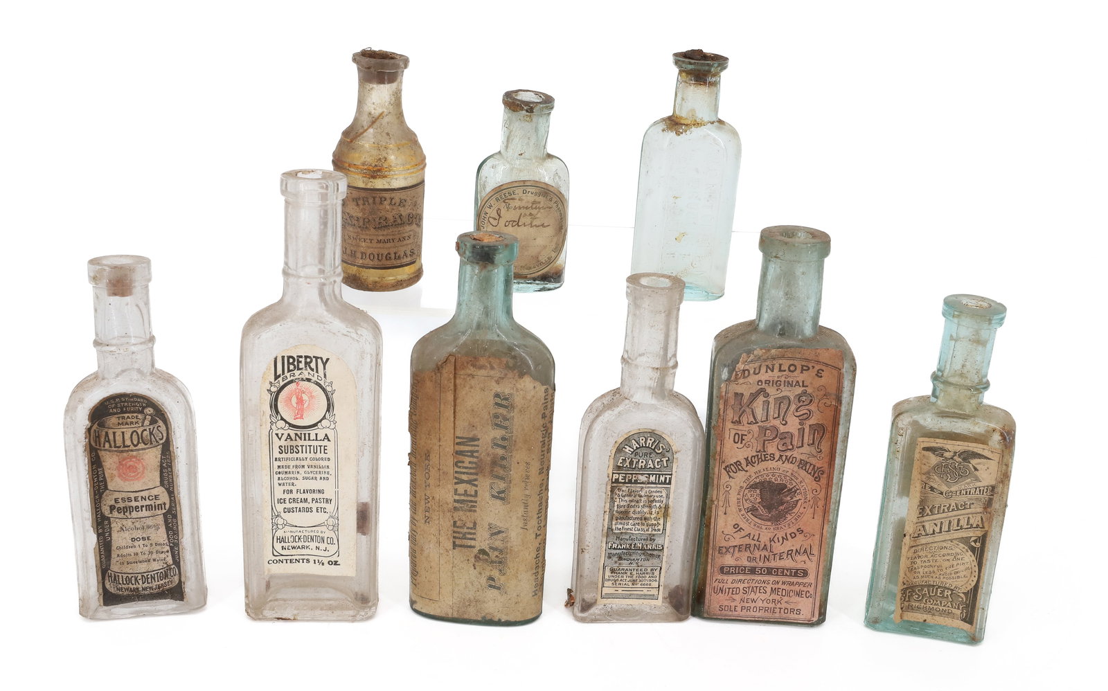 LOT OF ANTIQUE MEDICINE BOTTLES, PAPER LABELS: LIBERTY BRAND VANILLA (NEWARK), THE MEXICAN PAIN KILLER (NEW YORK) 5 1/2", DUNLOP'S ORIGINAL KING OF PAIN (NEW YORK), HALLOCK'S ESSENCE OF PEPPERMINT AND MORE. PLUS, EMBOSSED BOTTLE "W.S. MITCHELL