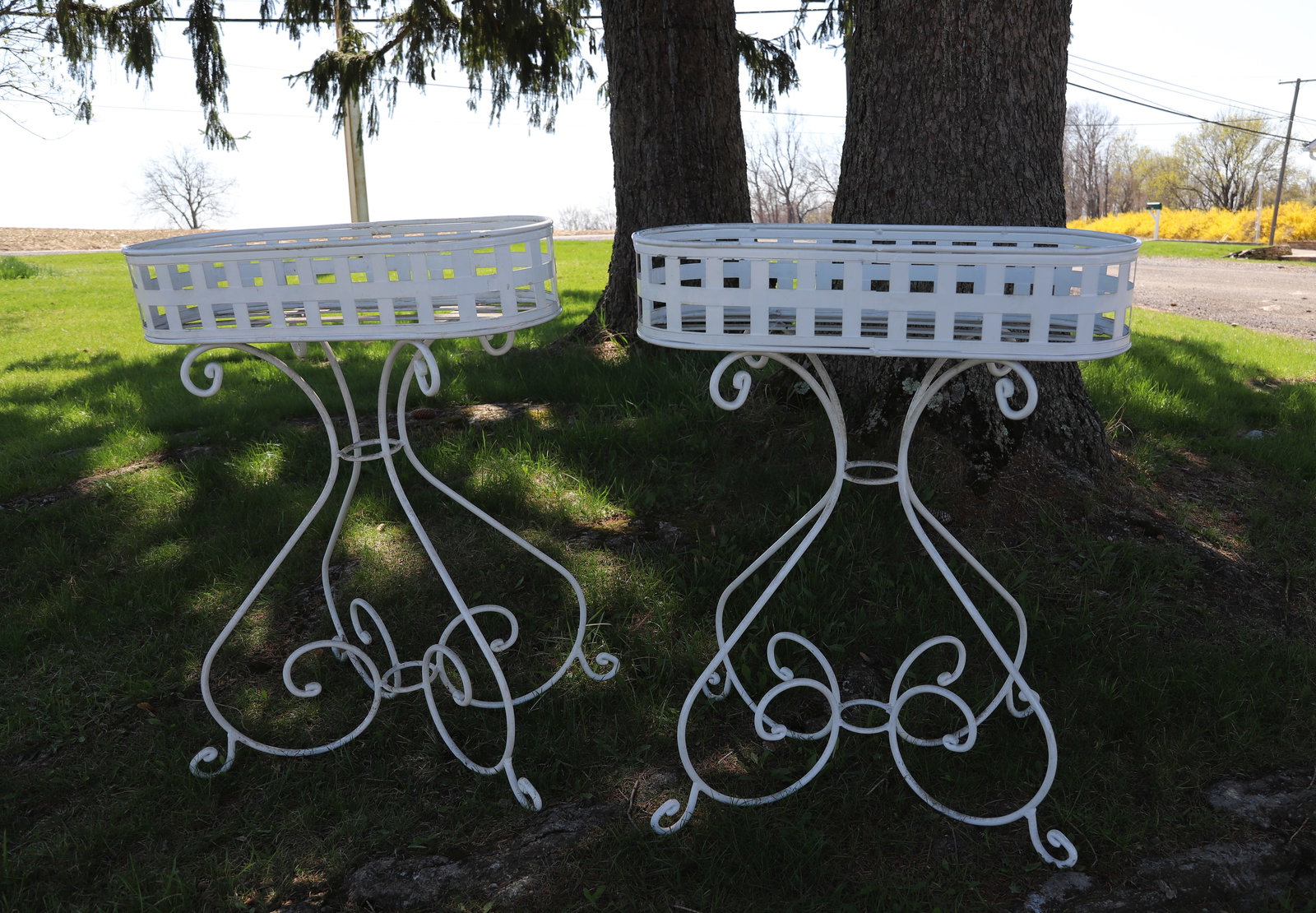 PAIR OF PAINTED METAL PLANT STANDS: OVAL ON WROUGHT METAL IRON BASES. 37" X 29" X 11 1/2". 6" DEEP. PLEASE READ CAREFULLY - ITEMS MUST BE PAID FOR THROUGH LIVE AUCTIONEERS OR WITH CASH OR CHECK IN PERSON - Terms for Purchasing and