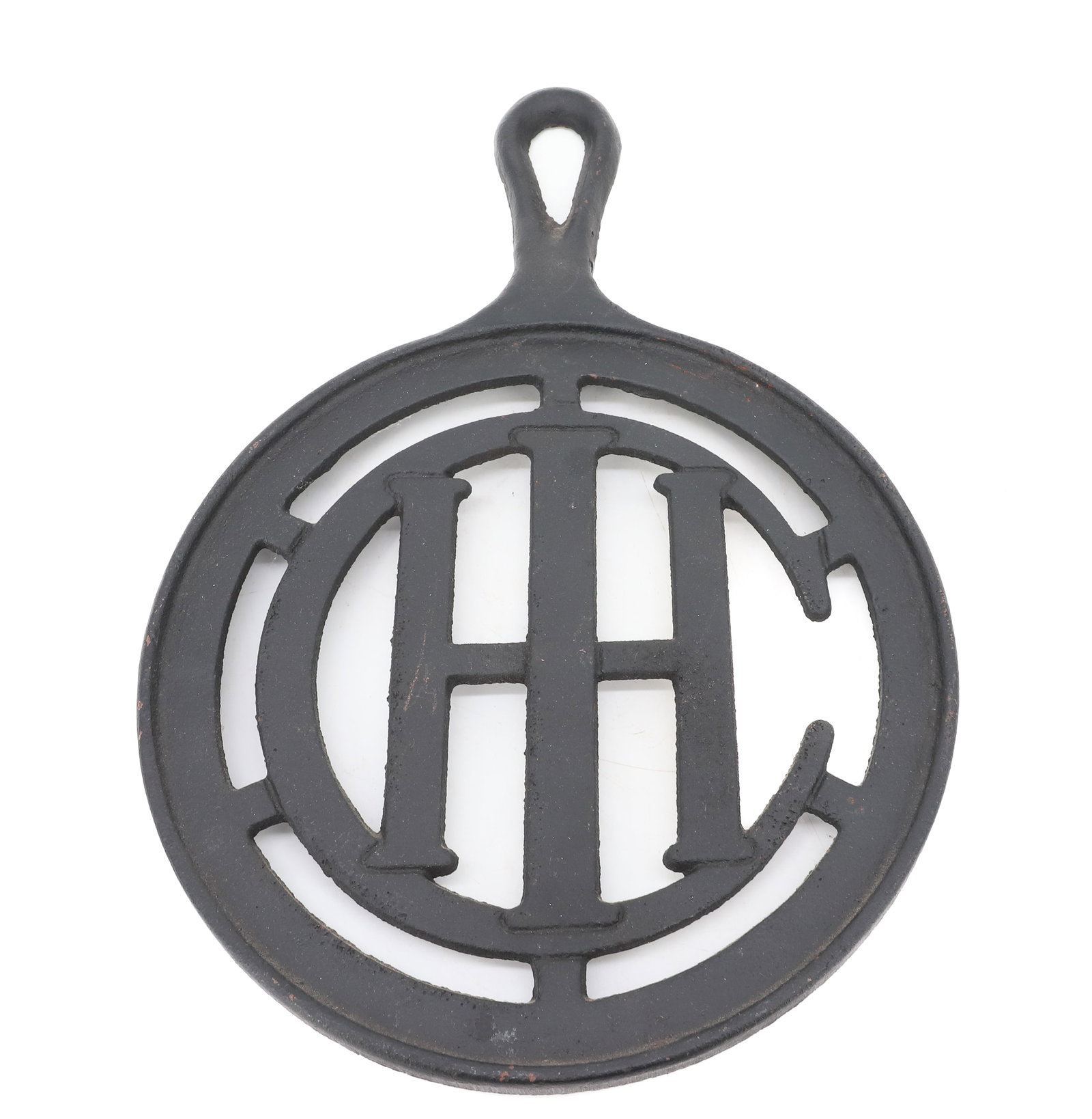 INTERNATIONAL HARVESTER TRIVET: IMPRESSED "27-C" ON BACK. 12 1/2" X 9". PLEASE READ CAREFULLY - ITEMS MUST BE PAID FOR THROUGH LIVE AUCTIONEERS OR WITH CASH OR CHECK IN PERSON - Terms for Purchasing and Shipping of Auction Items. Pl