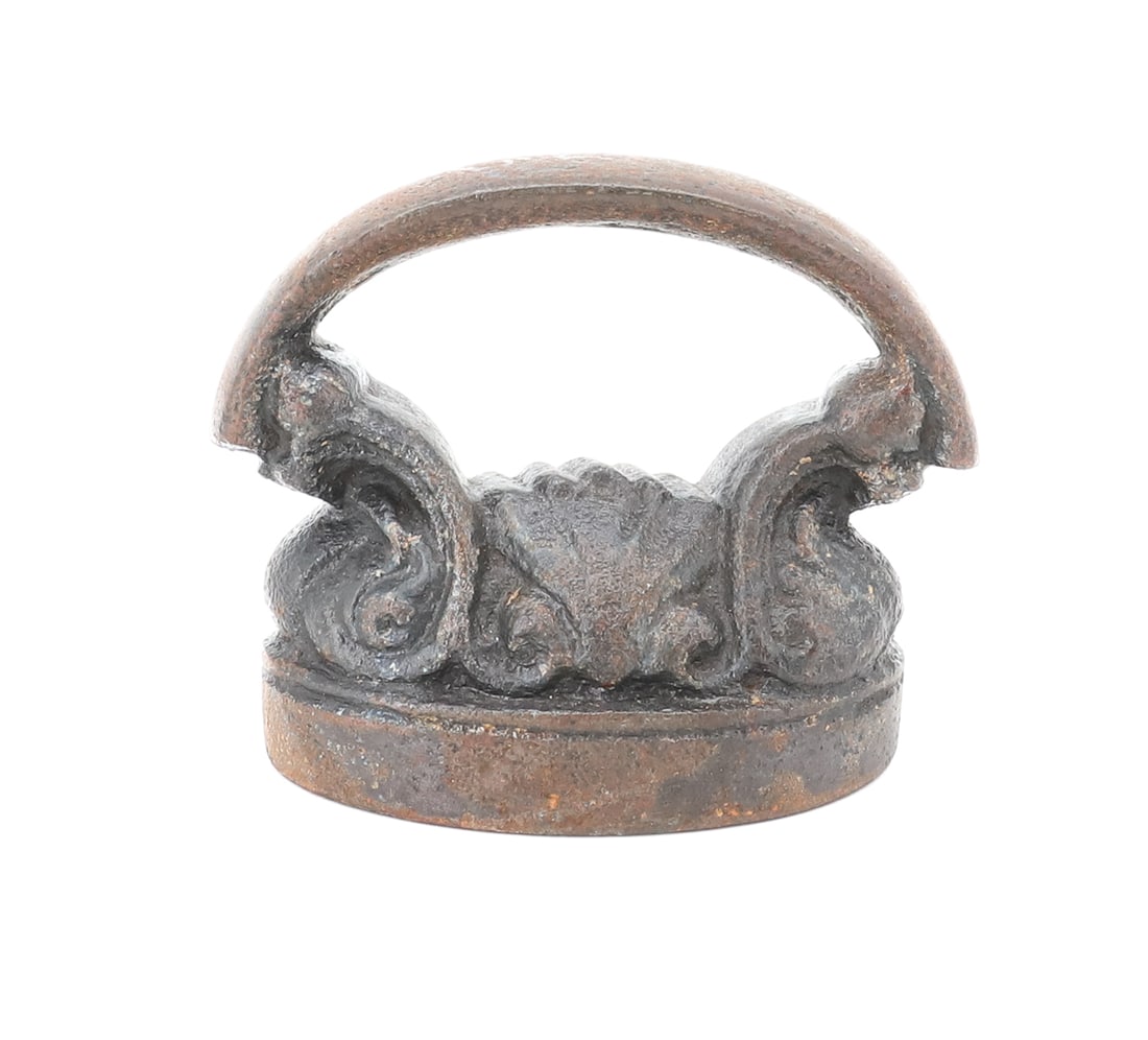 SMALL-SIZE FRENCH CAP IRON: DECORATED TOP WITH CURVED HANDLE. 3 1/4" L. PLEASE READ CAREFULLY - ITEMS MUST BE PAID FOR THROUGH LIVE AUCTIONEERS OR WITH CASH OR CHECK IN PERSON - Terms for Purchasing and Shipping of Auction Items