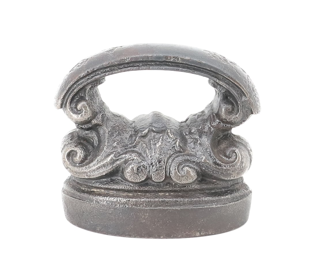 SMALL-SIZE FRENCH CAP IRON: DECORATED TOP WITH CURVED HANDLE. 2 3/4" L. PLEASE READ CAREFULLY - ITEMS MUST BE PAID FOR THROUGH LIVE AUCTIONEERS OR WITH CASH OR CHECK IN PERSON - Terms for Purchasing and Shipping of Auction