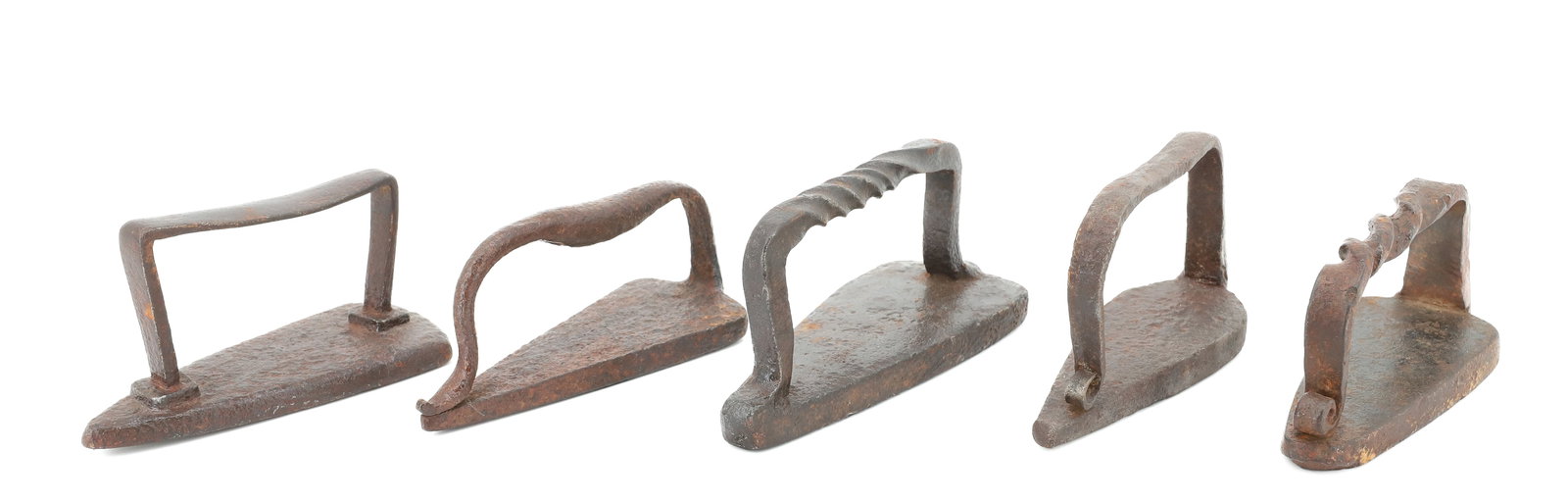 (5) PRIMITIVE FLAT IRONS: HANDWROUGHT. SLAVE AND PRIMITIVE STYLES. LARGEST 7". PLEASE READ CAREFULLY - ITEMS MUST BE PAID FOR THROUGH LIVE AUCTIONEERS OR WITH CASH OR CHECK IN PERSON - Terms for Purchasing and Shipping of