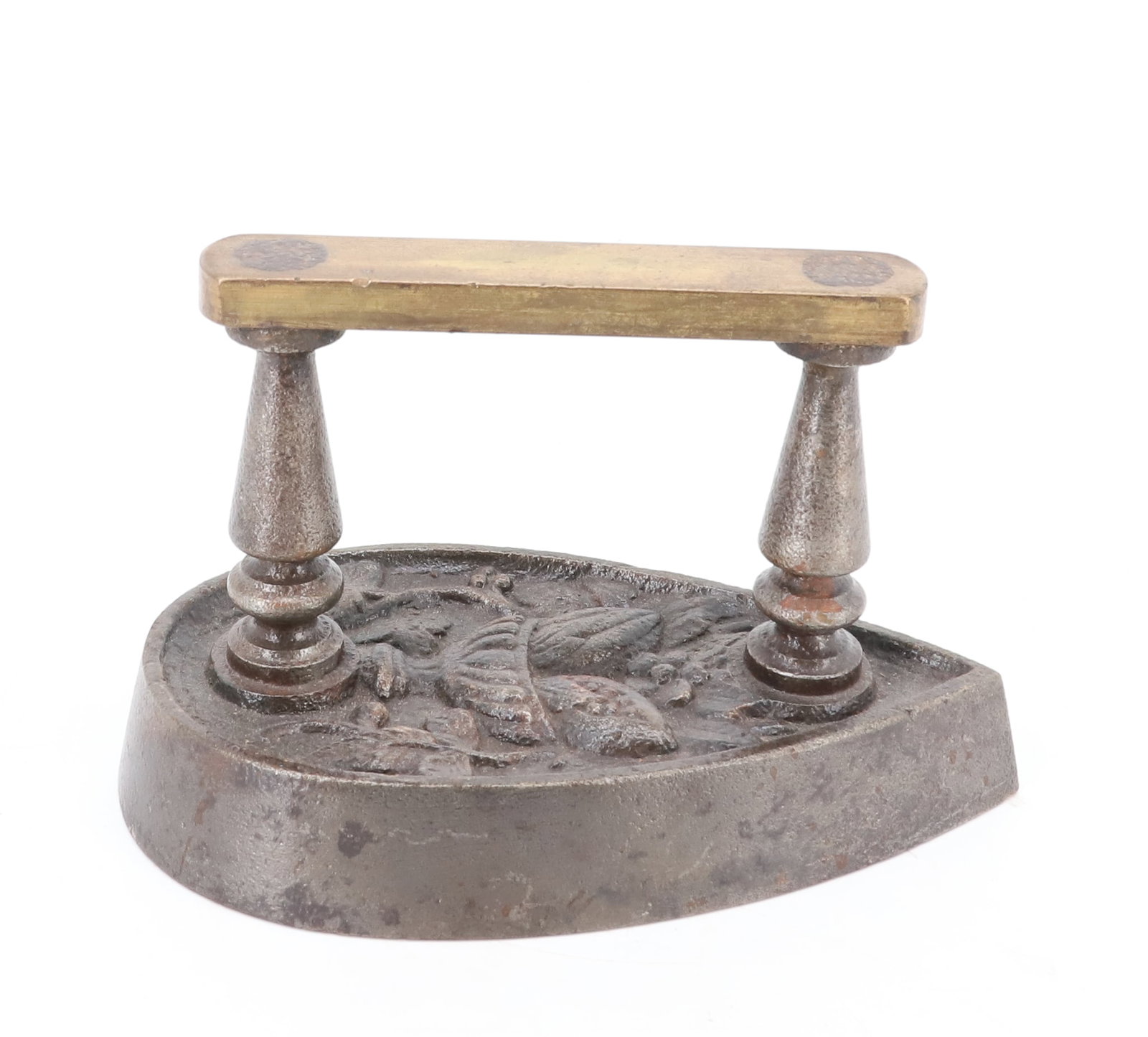 TEARDROP SHAPED FLAT IRON: EMBOSSED DESIGN ON TOP WITH FRUIT LEAVES AND BOWL. BRASS HANDGRIP WITH TURNED POSTS. 6 3/4" L. PLEASE READ CAREFULLY - ITEMS MUST BE PAID FOR THROUGH LIVE AUCTIONEERS OR WITH CASH OR CHECK IN PERSON -