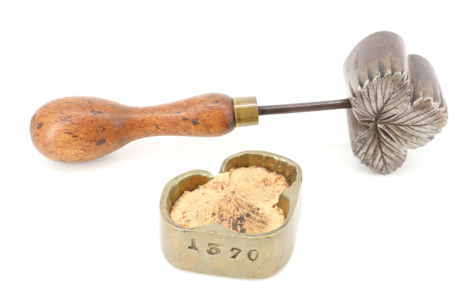 SMALL SIZE FLOWER HAT IRON: LEAF DESIGN WITH BRASS AND STEEL HEAD. WOODEN HANDLE. 2" X 2 1/2". PLEASE READ CAREFULLY - ITEMS MUST BE PAID FOR THROUGH LIVE AUCTIONEERS OR WITH CASH OR CHECK IN PERSON - Terms for Purchasing and Sh