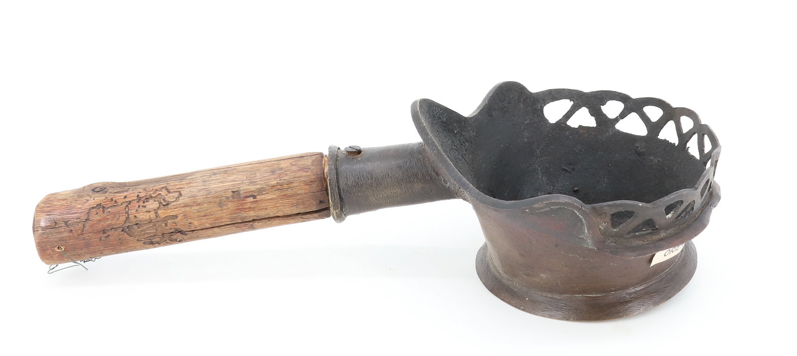 ORIENTAL BRASS PAN IRON: WOODEN HANDLE. MEASURES 12 1/2" L. CUT-OUT TOP DECORATION. PLEASE READ CAREFULLY - ITEMS MUST BE PAID FOR THROUGH LIVE AUCTIONEERS OR WITH CASH OR CHECK IN PERSON - Terms for Purchasing and Shipping