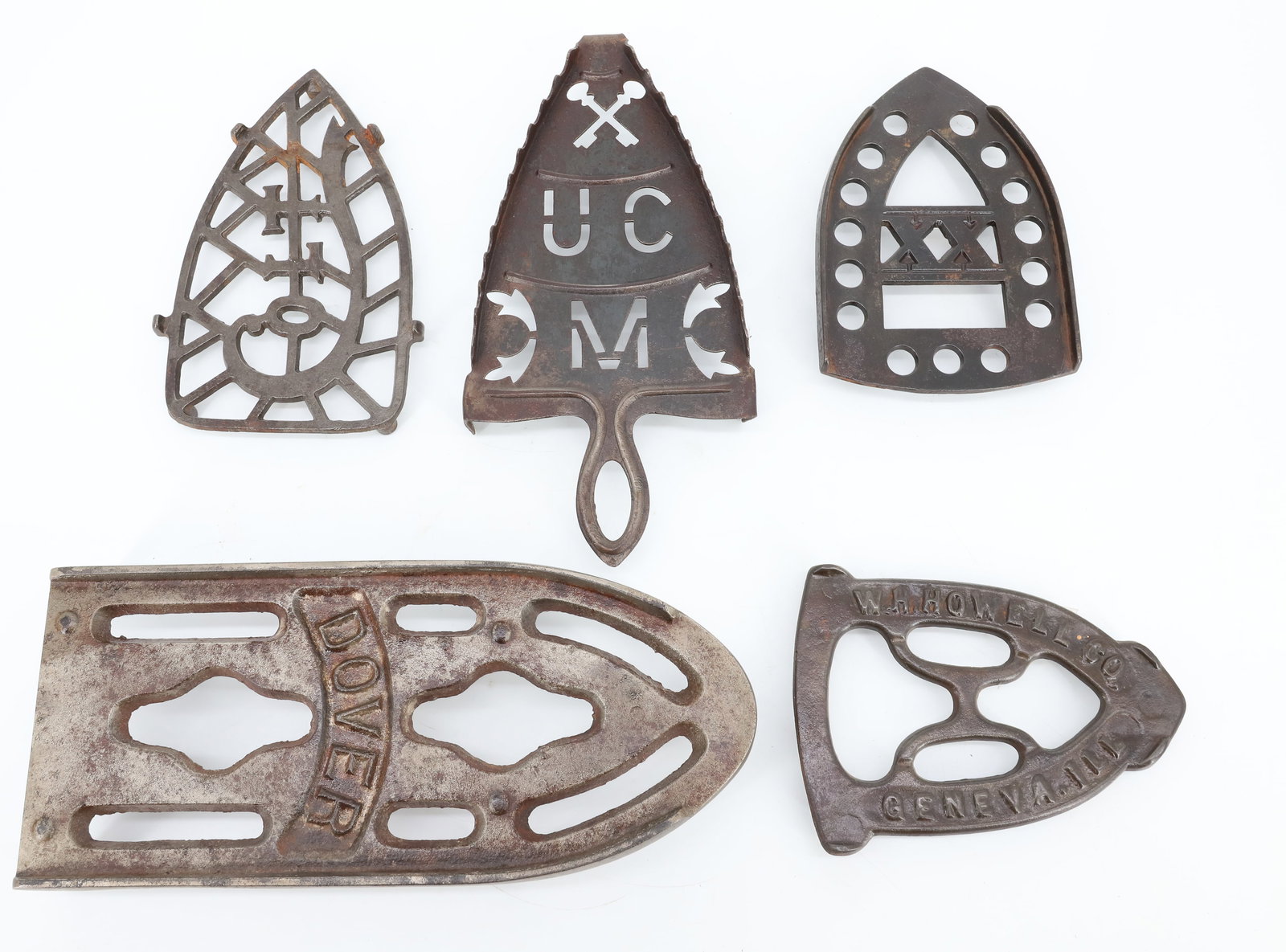 LOT OF ANTIQUE PRESSING IRON TRIVETS: (5) INCLUDING: LARGE DOVER TAILOR TRIVET, W.H. HOWELL & CO., "XX" RETICULATED, HANDMADE SHEET METAL W/ CUT-OUTS AND COLT. PLEASE READ CAREFULLY - ITEMS MUST BE PAID FOR THROUGH LIVE AUCTIONEERS OR WIT