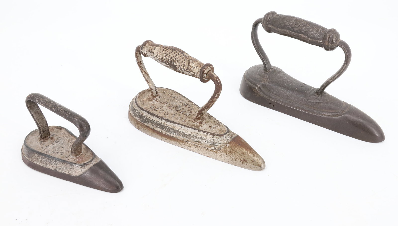 (3) ANTIQUE SLEEVE IRONS: TWO SILVER PAINTED AND EMBOSSED "OBER, CHAGRIN FALLS, O" . LARGEST 7 1/4" L. (LABELED RUFFLE IRON ON BOTTOM). OBER IRONS ARE 4 1/2" AND 6 3/4" PLEASE READ CAREFULLY - ITEMS MUST BE PAID FOR THROUGH