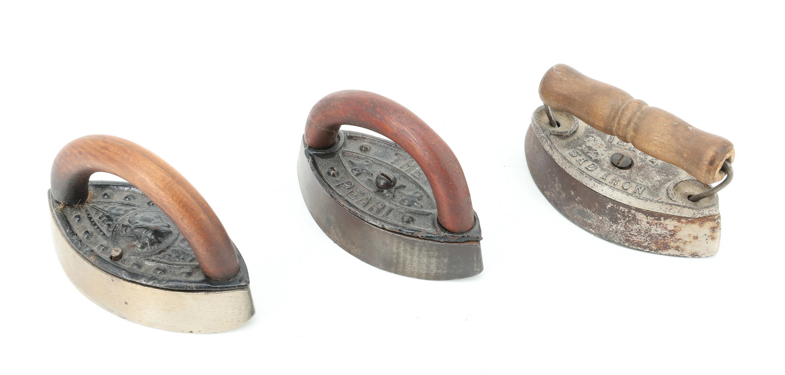(3) SMALL SIZE DOUBLE POINT IRONS: INCLUDING: THE PEARL , IDEAL SAD IRON AND ONE WITH EMBOSSED CAMEO. ARCHED HANDLES. 3 1/2" TO 3 7/8". PLEASE READ CAREFULLY - ITEMS MUST BE PAID FOR THROUGH LIVE AUCTIONEERS OR WITH CASH OR CHECK IN