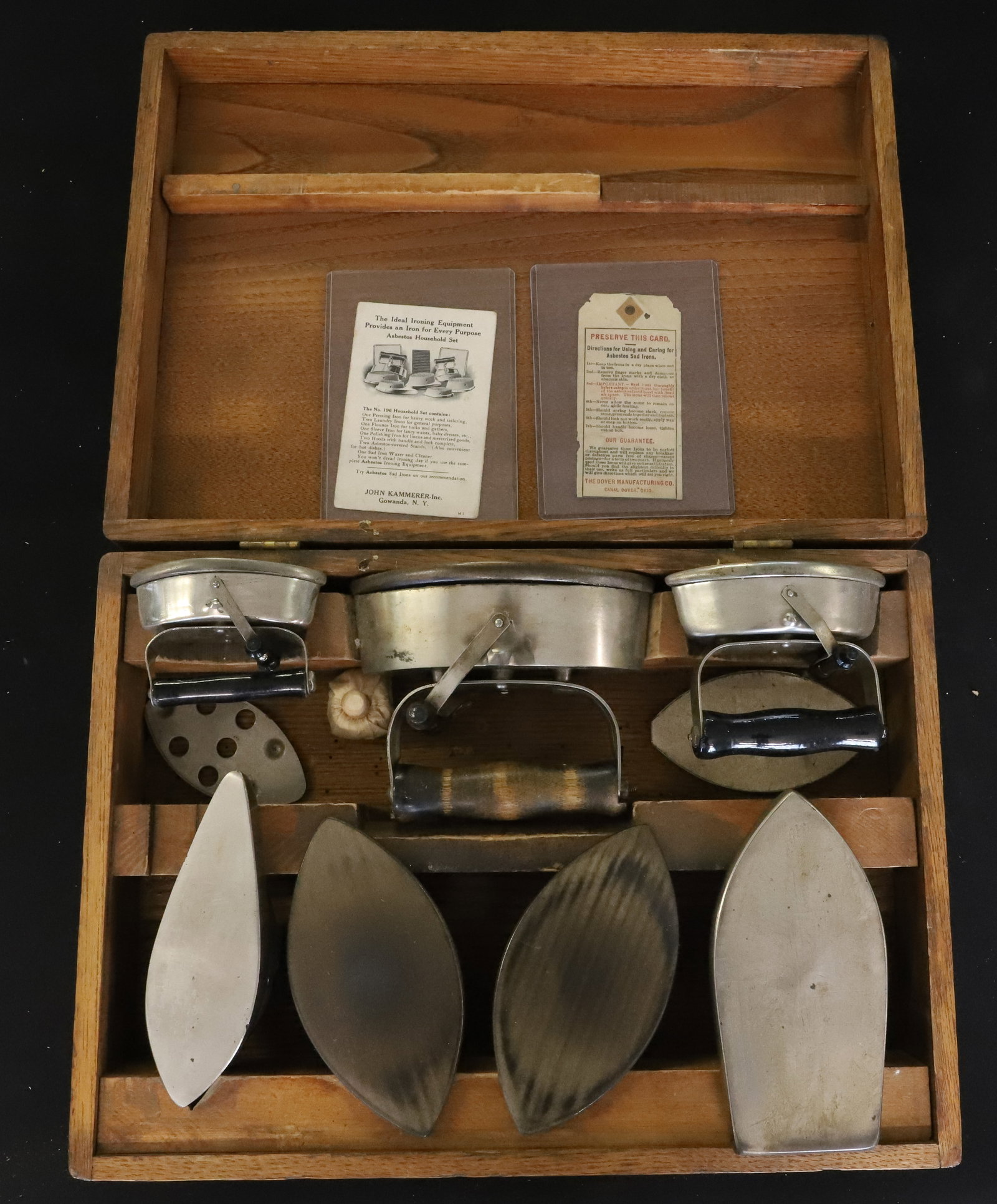 #196 HOUSEHOLD IRON SET: INCLUDES: ONE PRESSING IRON, LAUNDRY IRONS, FLOUNCE IRON, SLEEVE IRON AND POLISHING IRON. IN OAK BOX. PLEASE READ CAREFULLY - ITEMS MUST BE PAID FOR THROUGH LIVE AUCTIONEERS OR WITH CASH OR CHECK IN