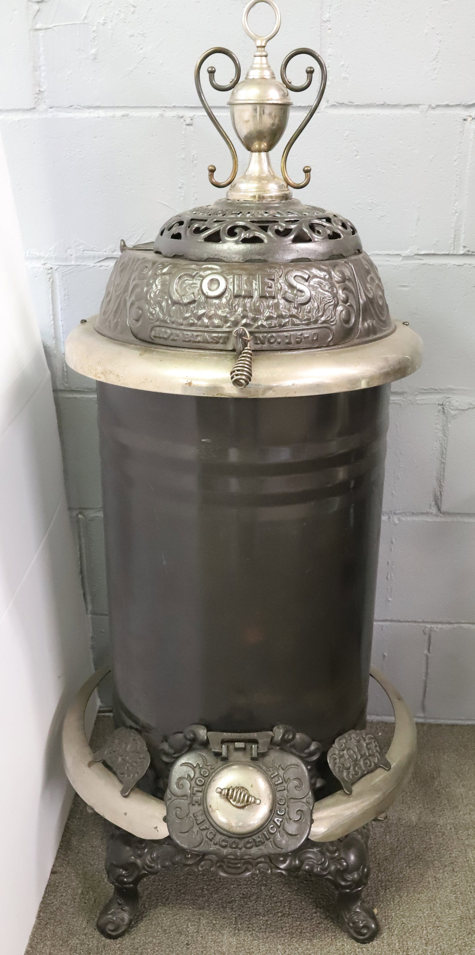 ANTIQUE CAST IRON COLE'S HOT BLAST STOVE: MRKD. COLE MFG. CO. CHICAGO, ILL. CAST IRON, NICKEL. 46" H. AND 20" D. AT BOTTOM. PLEASE READ CAREFULLY - ITEMS MUST BE PAID FOR THROUGH LIVE AUCTIONEERS OR WITH CASH OR CHECK IN PERSON - Terms for
